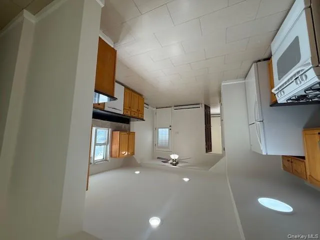 Kitchen with range, recessed lighting, dishwasher, light tile patterned floors, and ceiling fan Kitchen with range, recessed lighting, dishwasher, light tile patterned floors, and ceiling fan