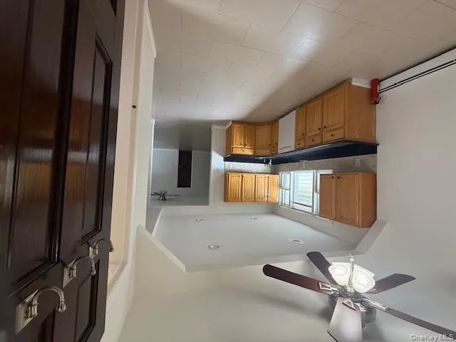 Kitchen with ceiling fan, dark countertops, backsplash, stainless steel dishwasher, and recessed lighting Kitchen with ceiling fan, dark countertops, backsplash, stainless steel dishwasher, and recessed lighting