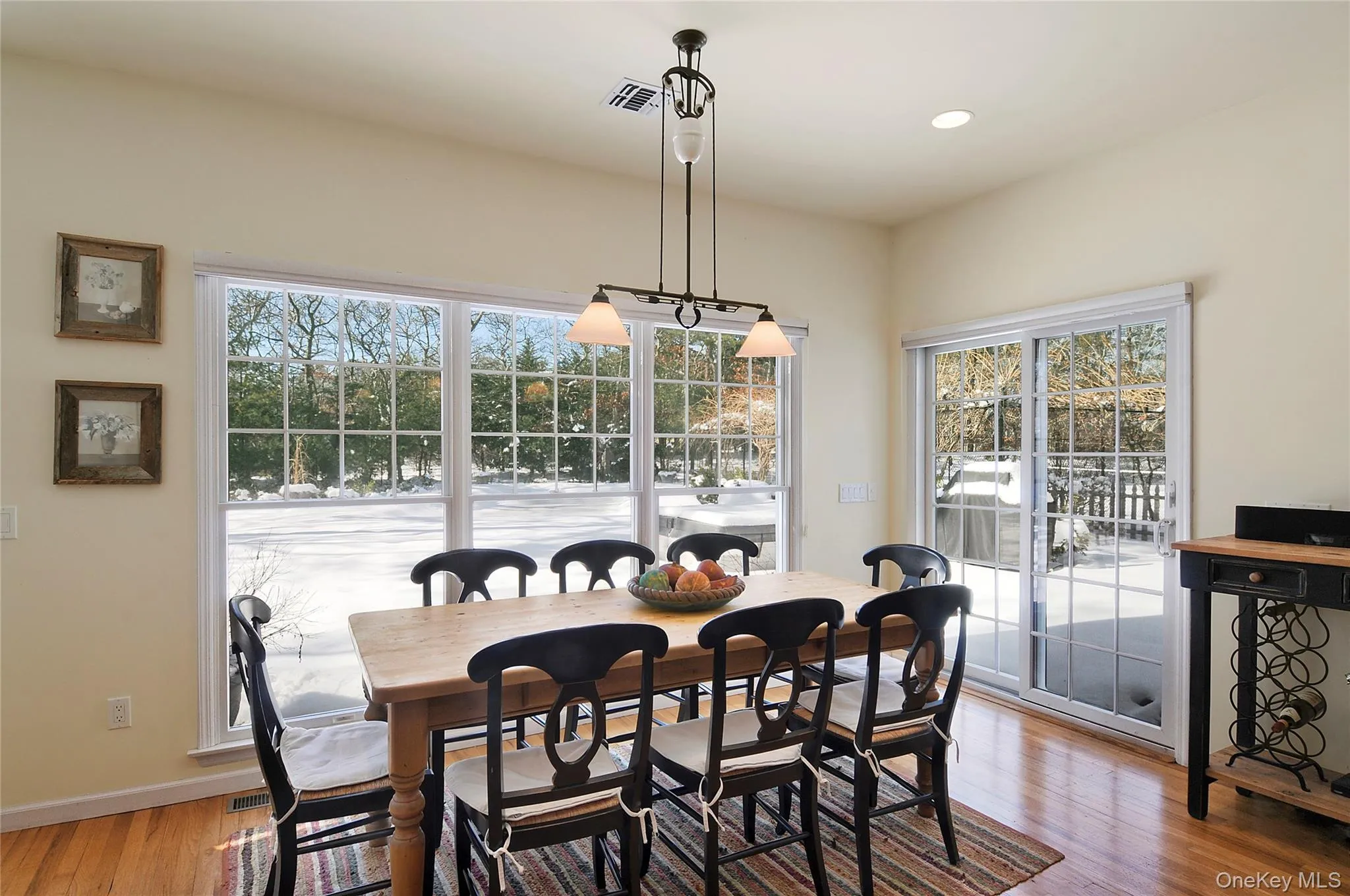Dining area with light wood-style flooring and recessed lighting Dining area with light wood-style flooring and recessed lighting