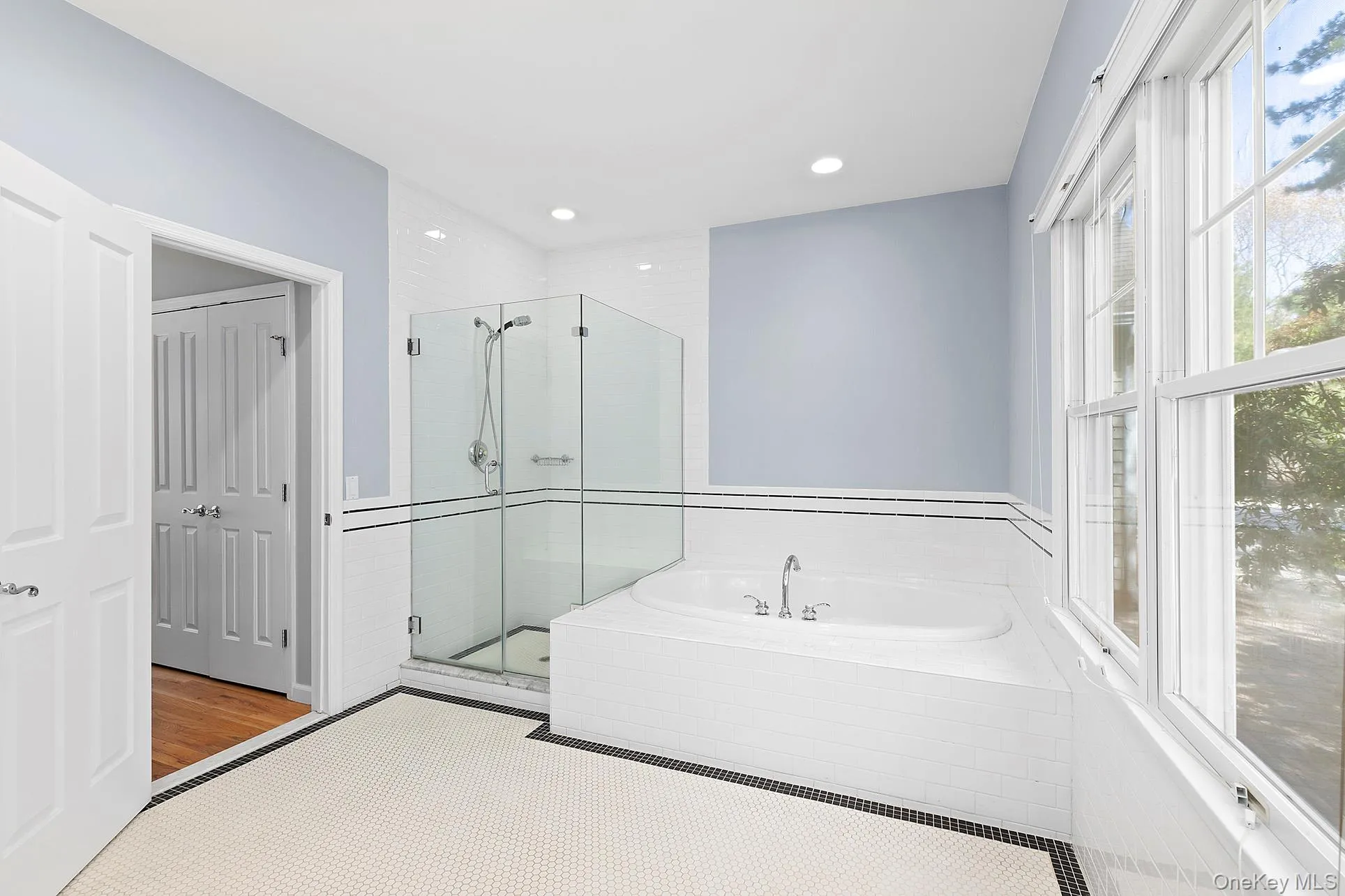 Full bathroom featuring a garden tub, a stall shower, and recessed lighting Full bathroom featuring a garden tub, a stall shower, and recessed lighting