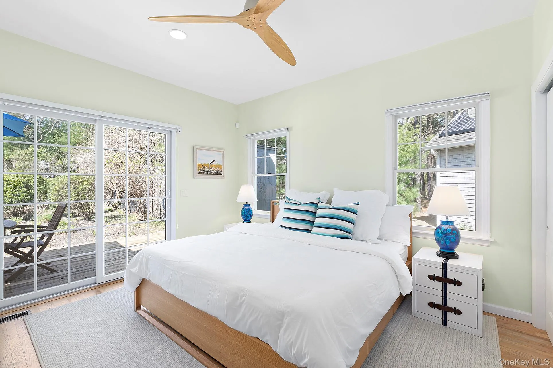 Bedroom with wood finished floors, access to outside, a ceiling fan, multiple windows, and recessed lighting Bedroom with wood finished floors, access to outside, a ceiling fan, multiple windows, and recessed lighting