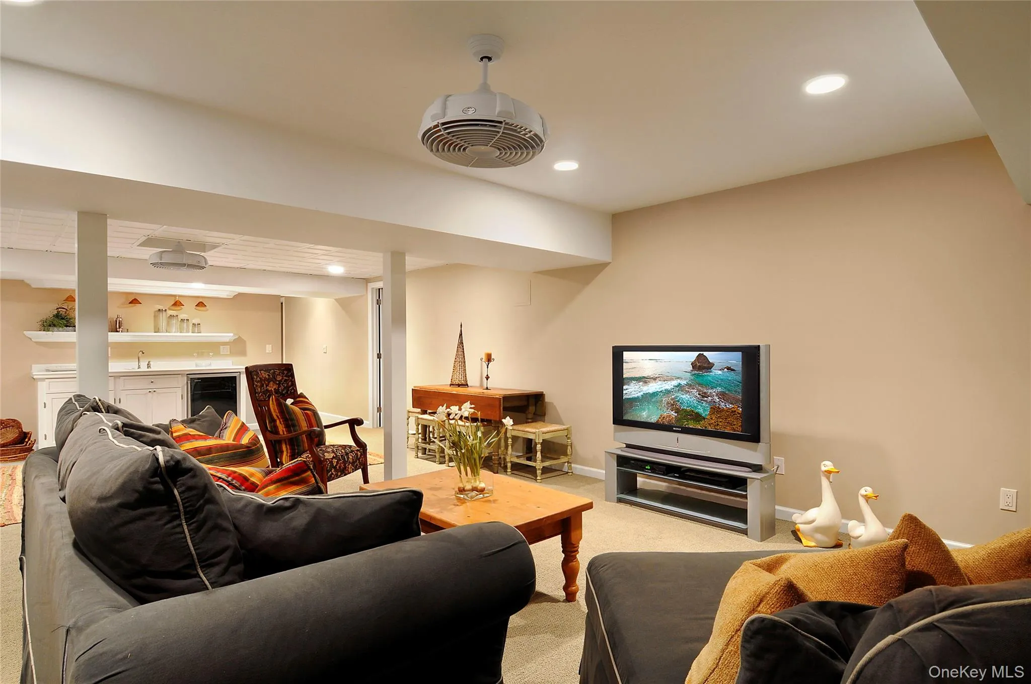 Living area with recessed lighting, carpet flooring, and beverage cooler Living area with recessed lighting, carpet flooring, and beverage cooler