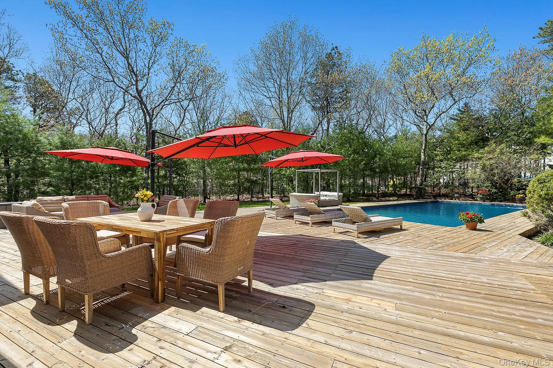 Wooden terrace with outdoor dining space and an outdoor pool Wooden terrace with outdoor dining space and an outdoor pool