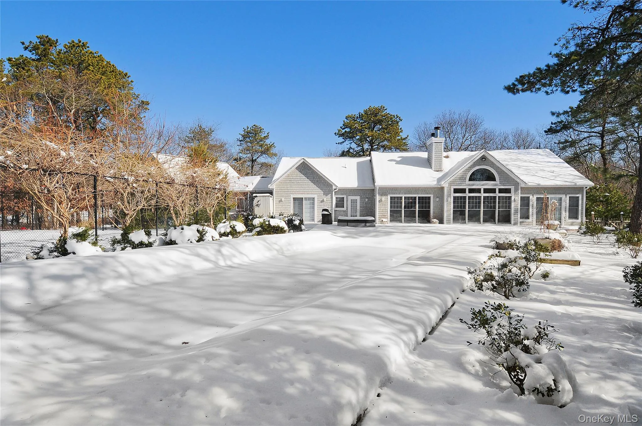 Snow covered house featuring a chimney Snow covered house featuring a chimney