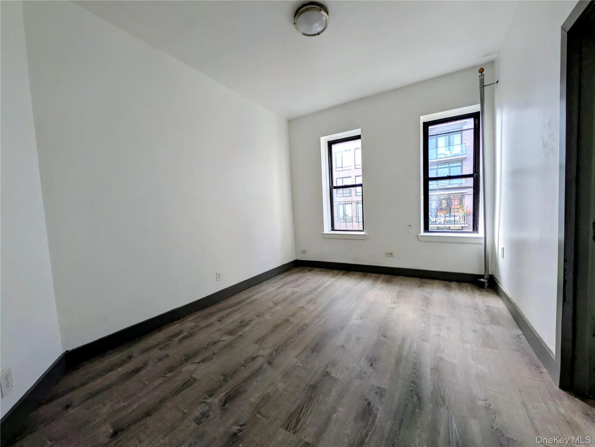 Spare room with light wood finished floors and baseboards Spare room with light wood finished floors and baseboards