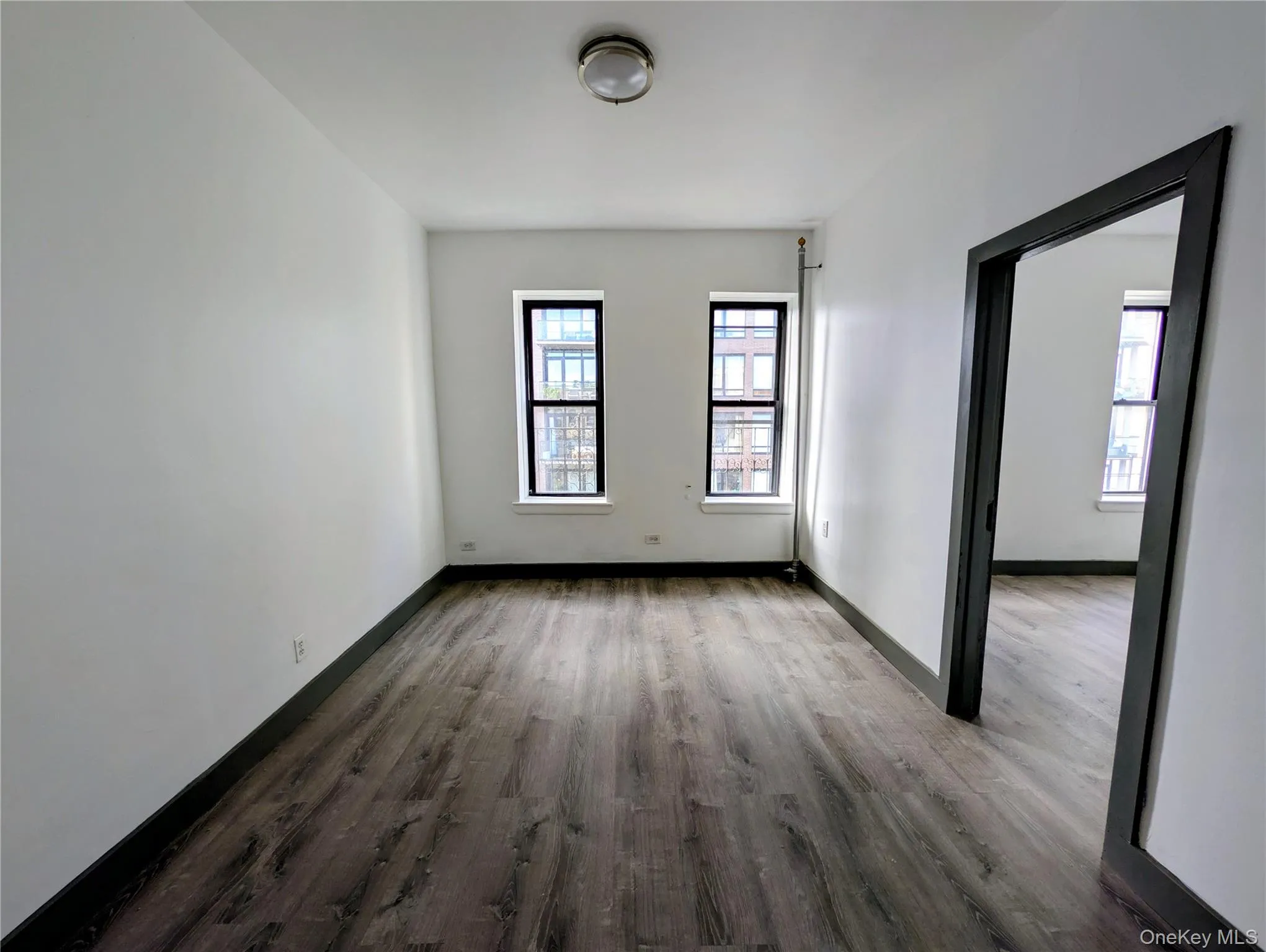 Empty room featuring light wood-style floors and baseboards Empty room featuring light wood-style floors and baseboards