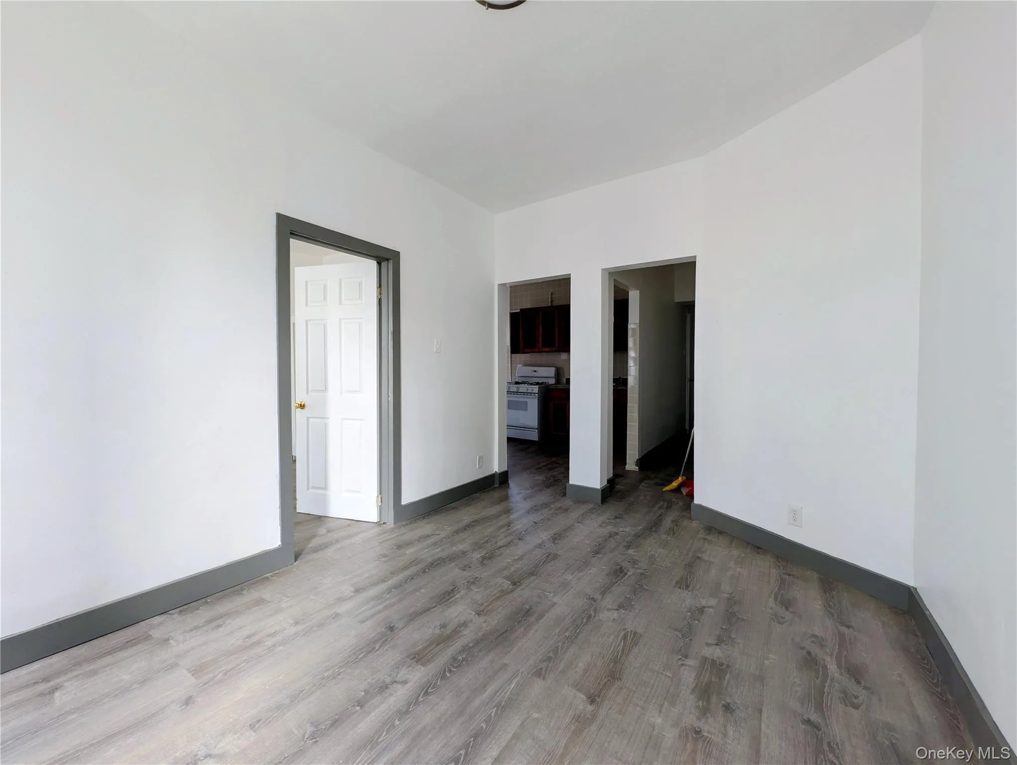 Spare room featuring wood finished floors and baseboards Spare room featuring wood finished floors and baseboards