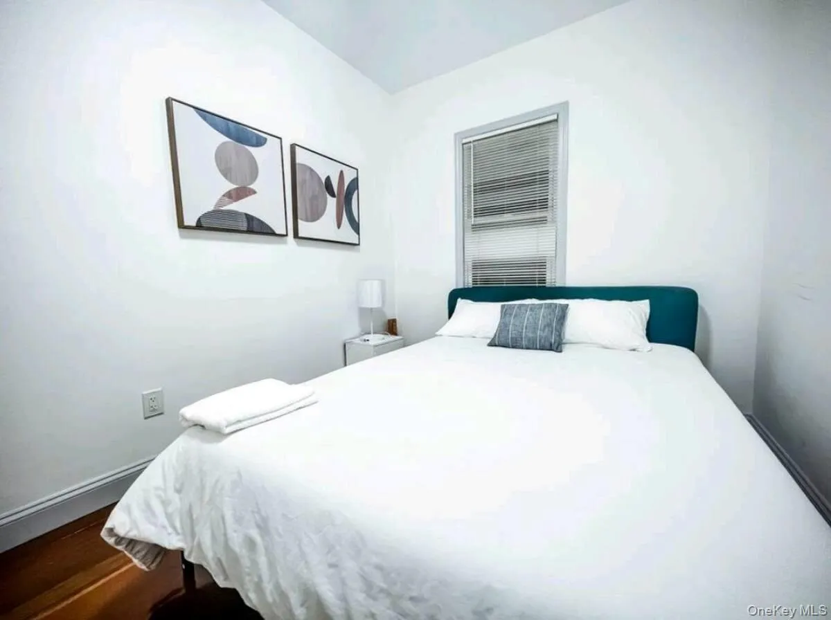 Bedroom featuring baseboards and dark wood-style floors Bedroom featuring baseboards and dark wood-style floors