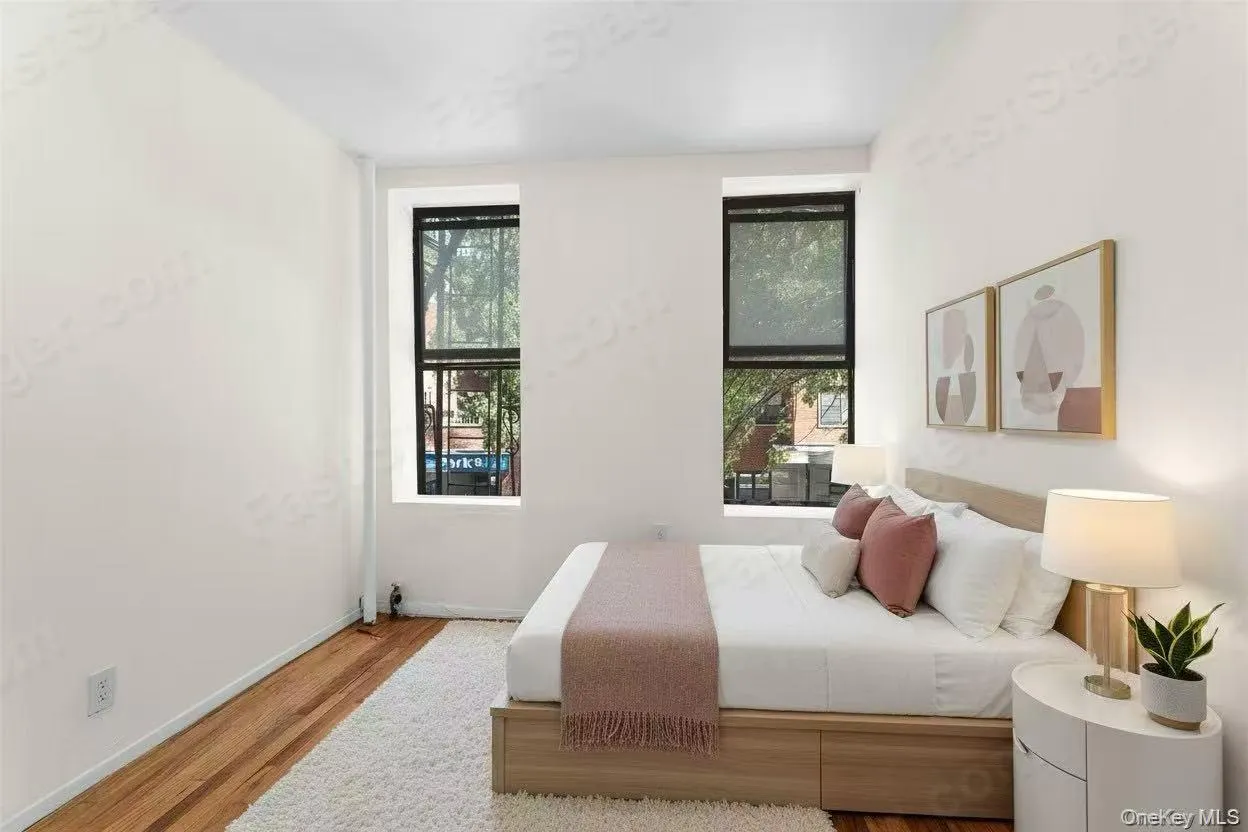 Bedroom with wood finished floors and baseboards Bedroom with wood finished floors and baseboards