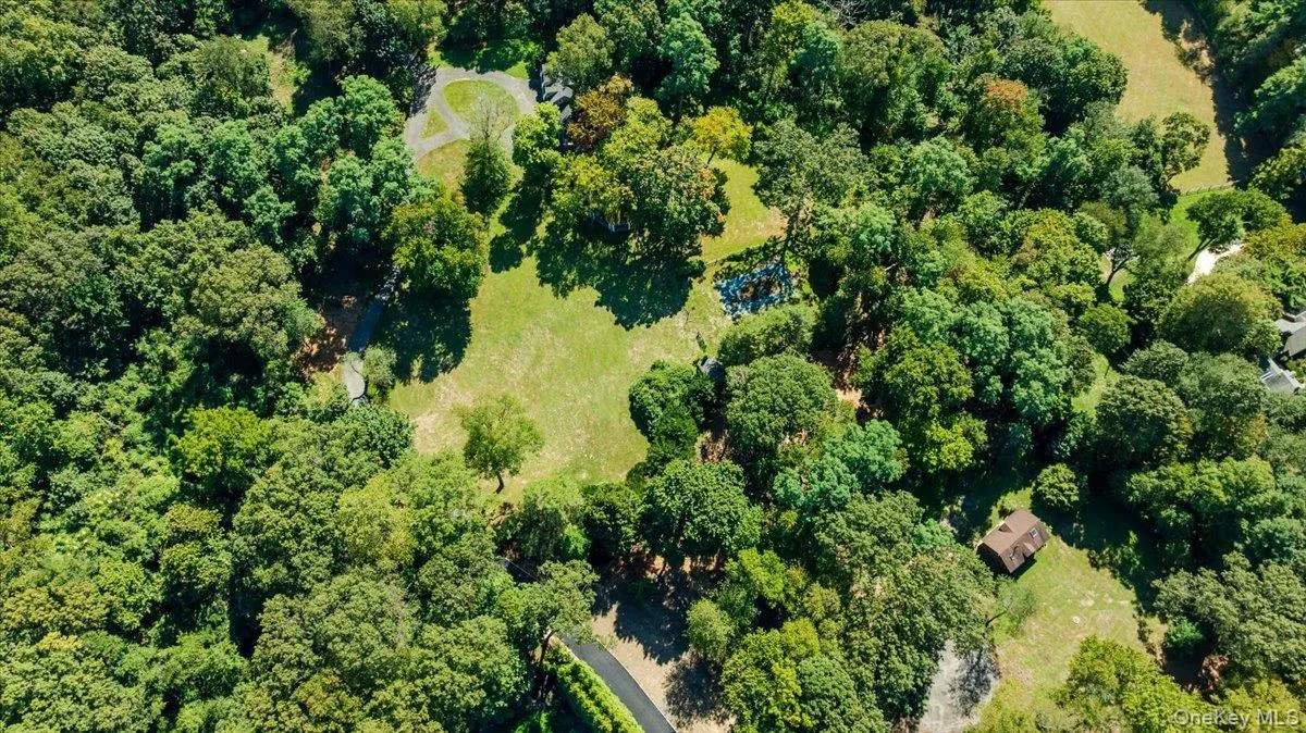 View of property location with a heavily wooded area View of property location with a heavily wooded area