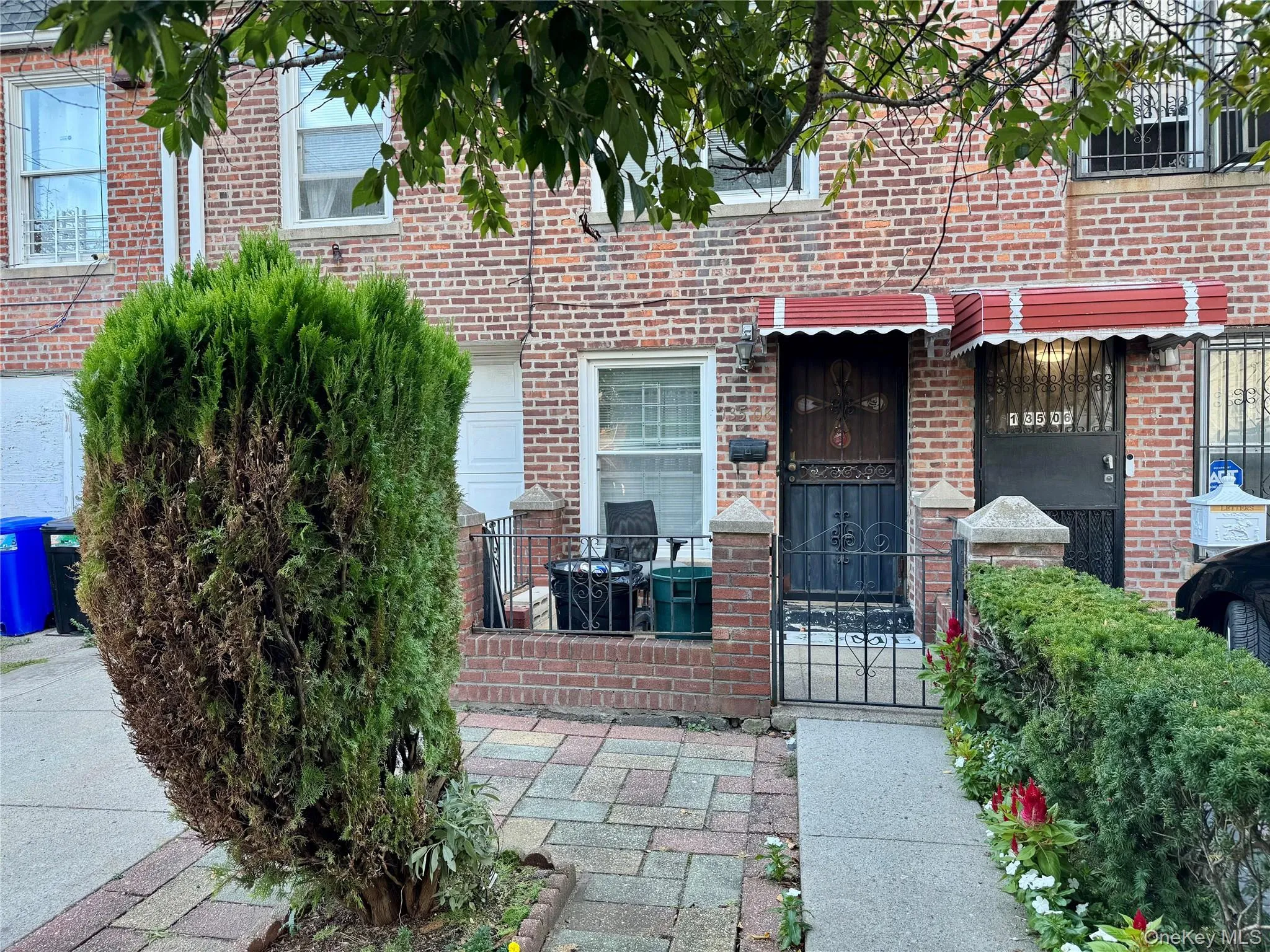 View of exterior entry featuring brick siding and a gate View of exterior entry featuring brick siding and a gate