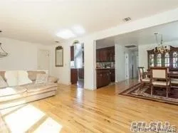 Living room featuring a chandelier and wood finished floors Living room featuring a chandelier and wood finished floors