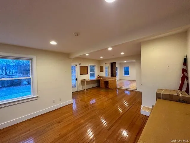 Unfurnished living room with wood-type flooring and recessed lighting Unfurnished living room with wood-type flooring and recessed lighting