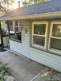View of side of property with a shingled roof View of side of property with a shingled roof