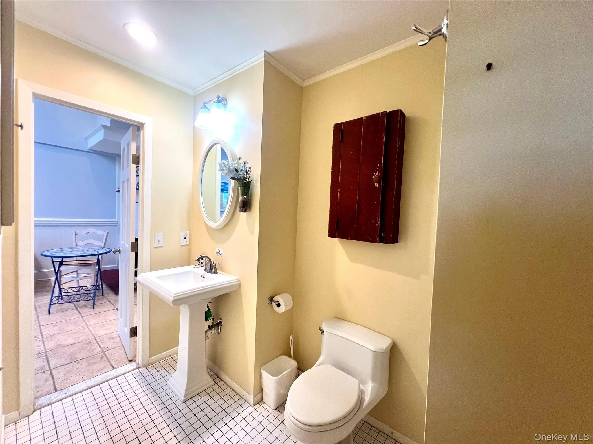 Full bath with tile patterned floors and ornamental molding Full bath with tile patterned floors and ornamental molding