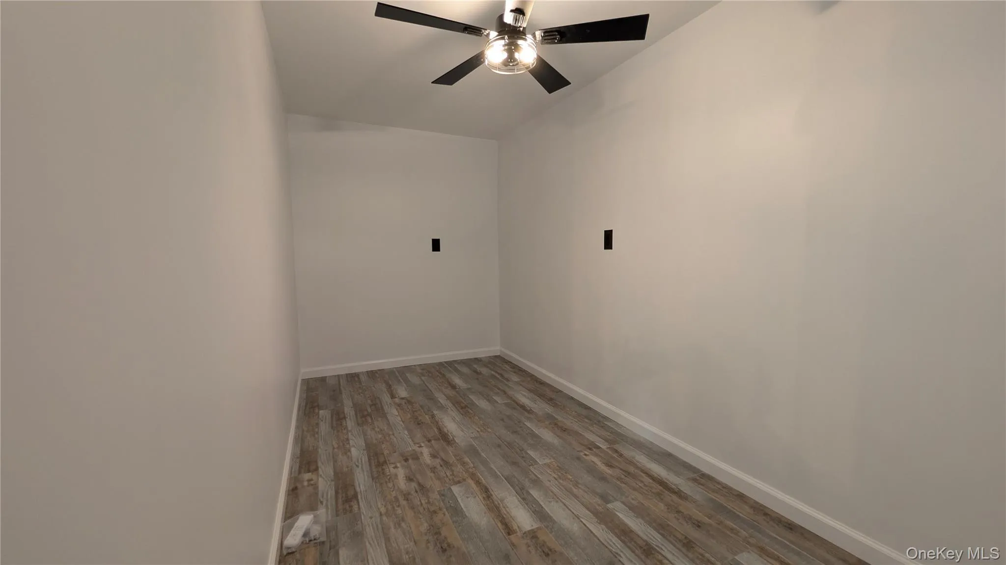 Spare room featuring light wood finished floors and ceiling fan Spare room featuring light wood finished floors and ceiling fan