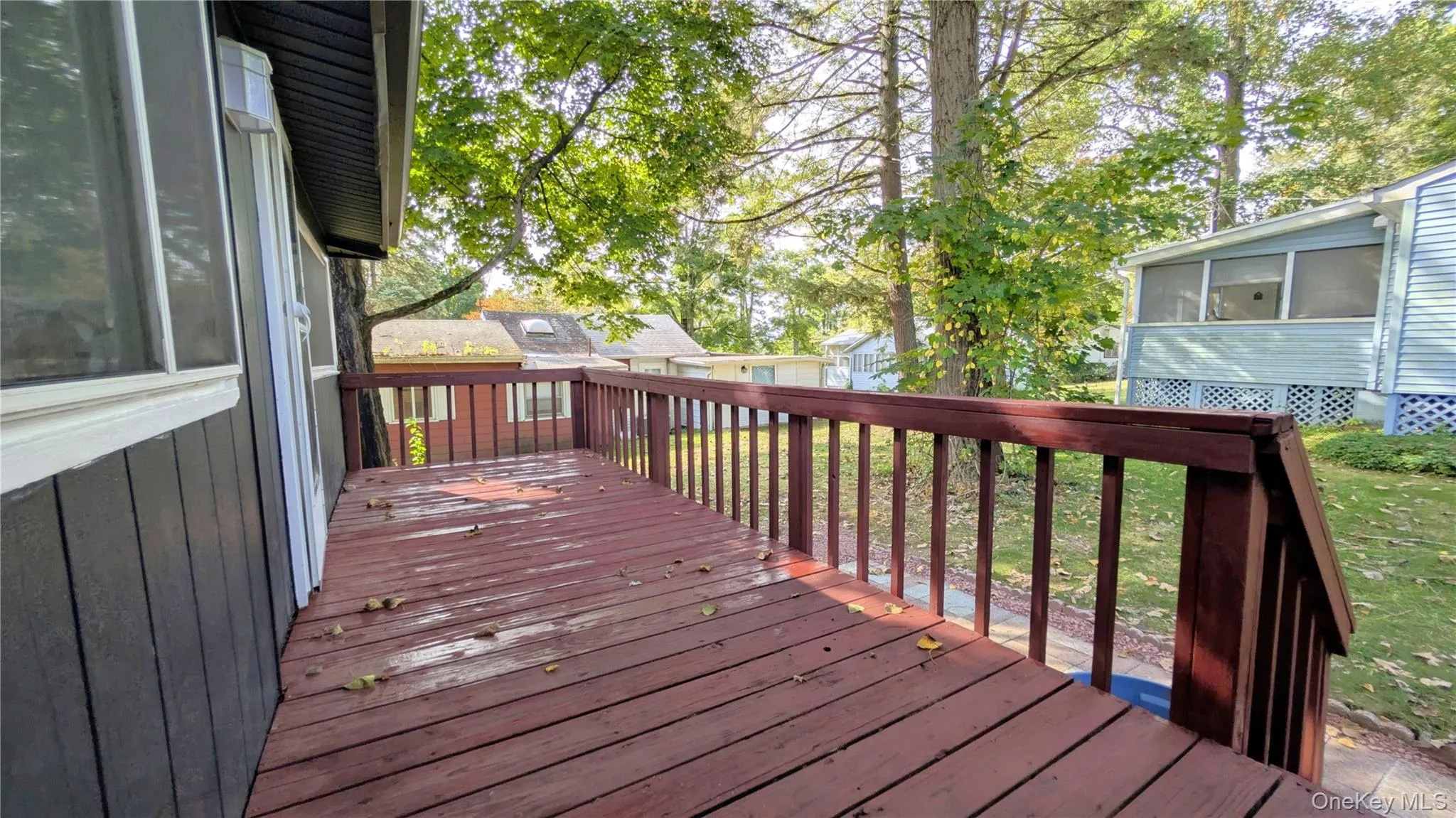 Deck featuring a sunroom Deck featuring a sunroom