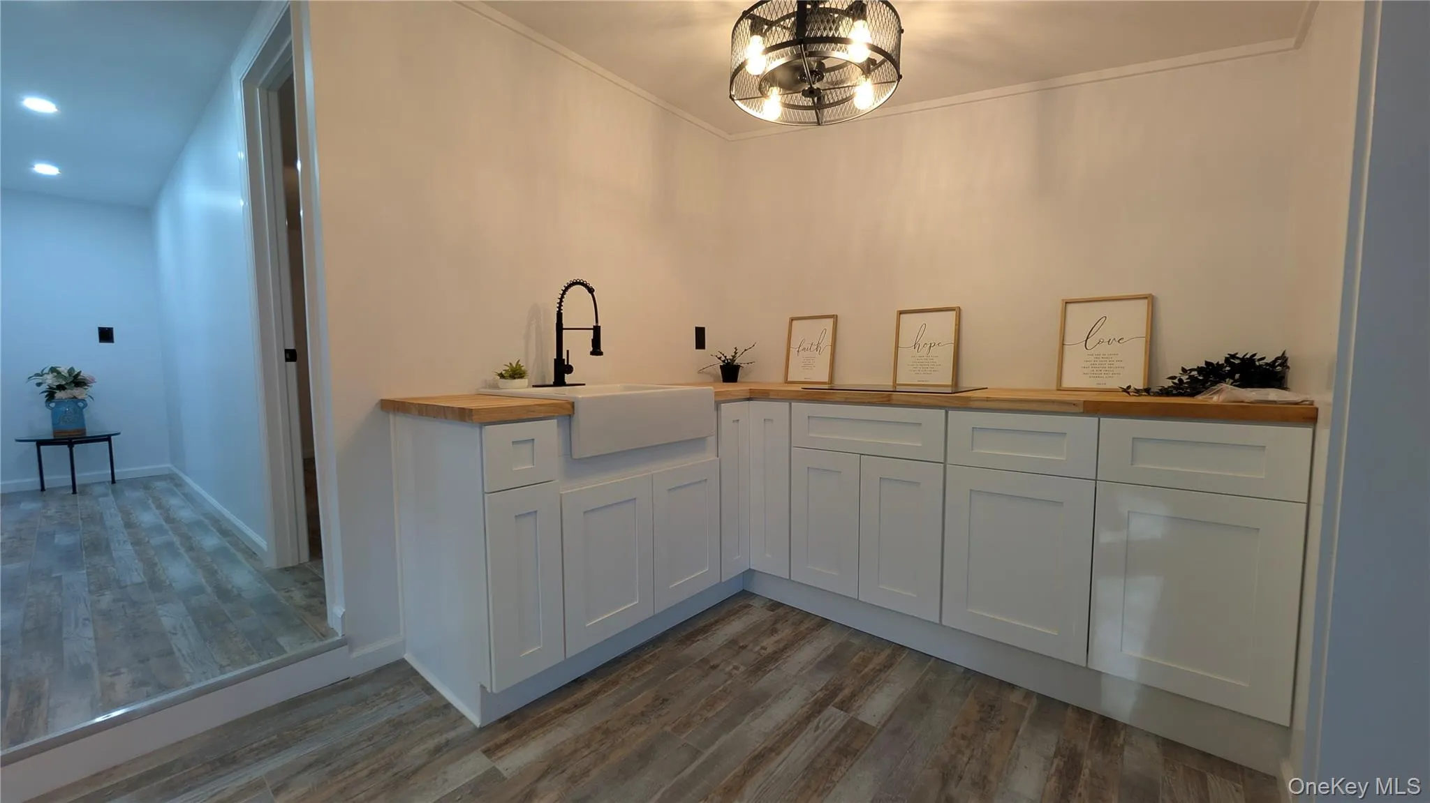 Bar area with white cabinetry, wood counters, dark wood finished floors, recessed lighting, and crown molding Bar area with white cabinetry, wood counters, dark wood finished floors, recessed lighting, and crown molding