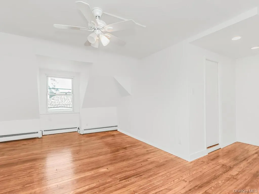 Additional living space with light wood-style flooring, ceiling fan, and recessed lighting Additional living space with light wood-style flooring, ceiling fan, and recessed lighting