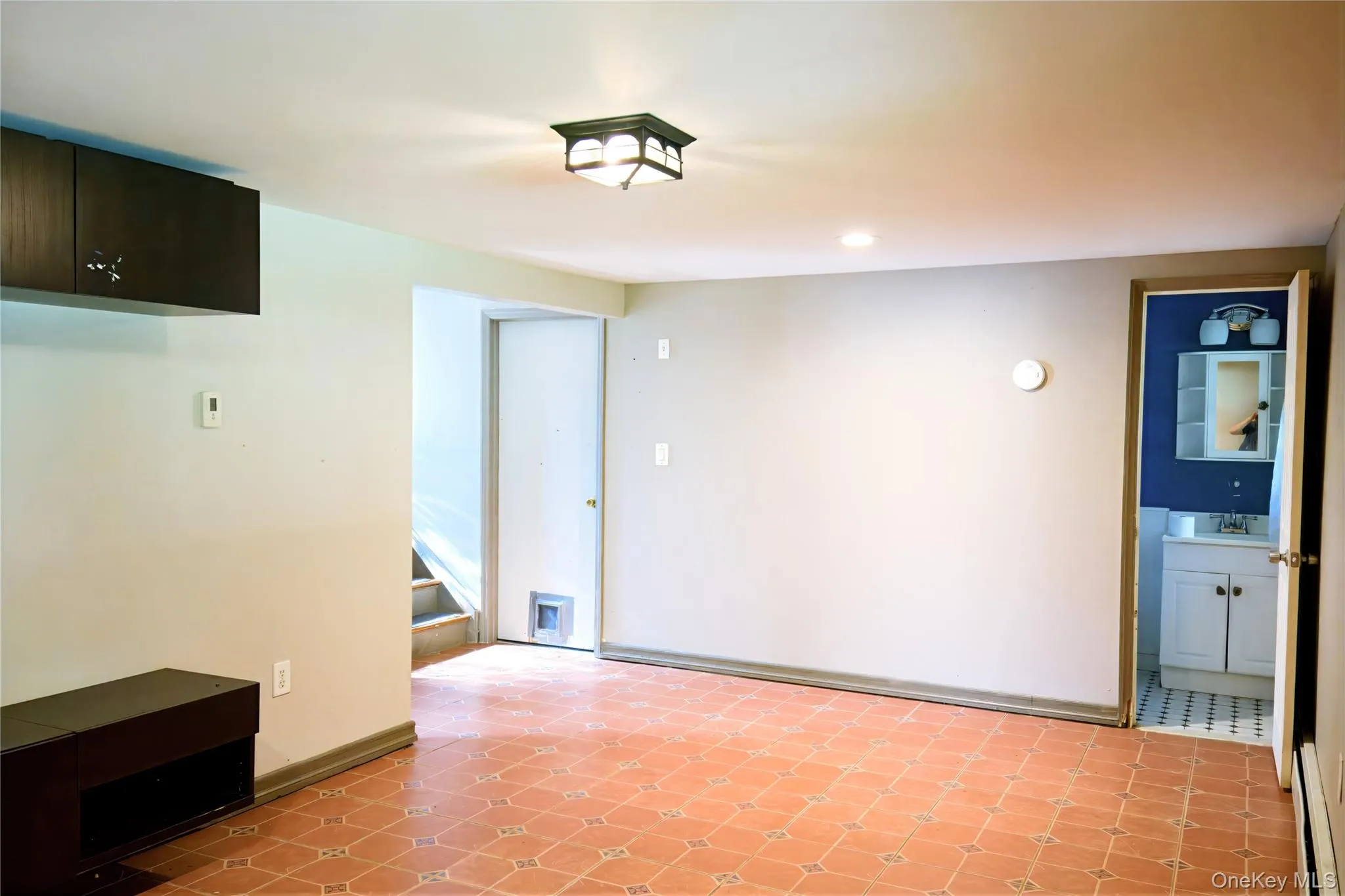 Unfurnished dining area featuring a baseboard radiator, recessed lighting, and stairs Unfurnished dining area featuring a baseboard radiator, recessed lighting, and stairs