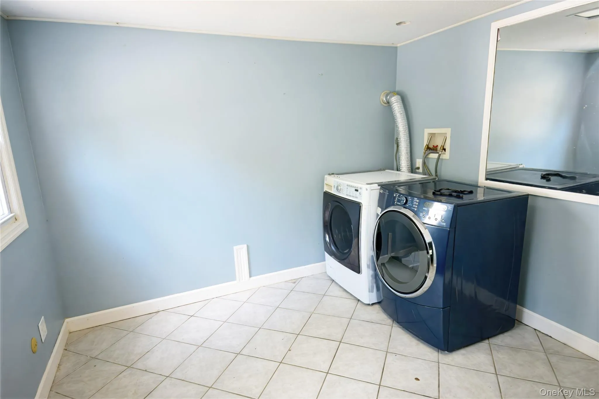 Laundry room featuring tile patterned flooring and independent washer and dryer Laundry room featuring tile patterned flooring and independent washer and dryer