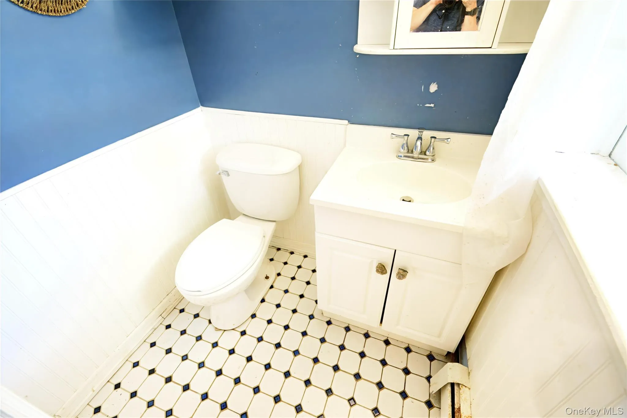 Bathroom with a wainscoted wall, vanity, and wooden walls Bathroom with a wainscoted wall, vanity, and wooden walls