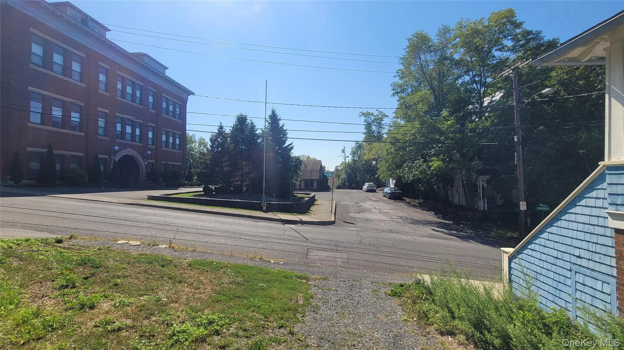 View of asphalt street with sidewalks View of asphalt street with sidewalks