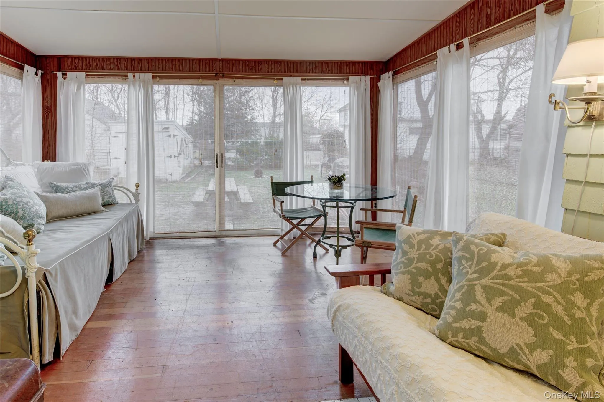 Sunroom featuring wood flooring Sunroom featuring wood flooring
