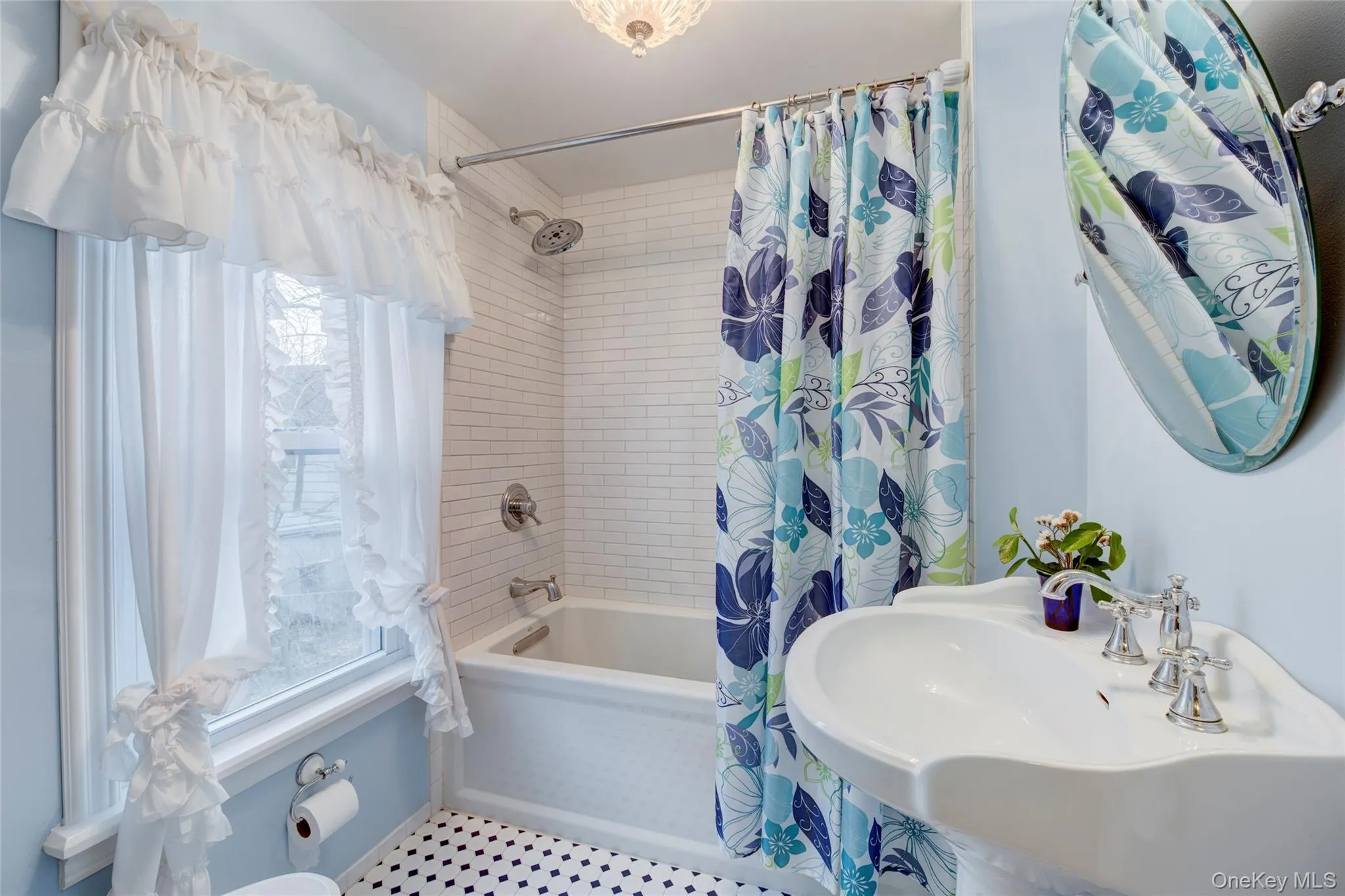 Bathroom with shower / tub combo and a sink Bathroom with shower / tub combo and a sink