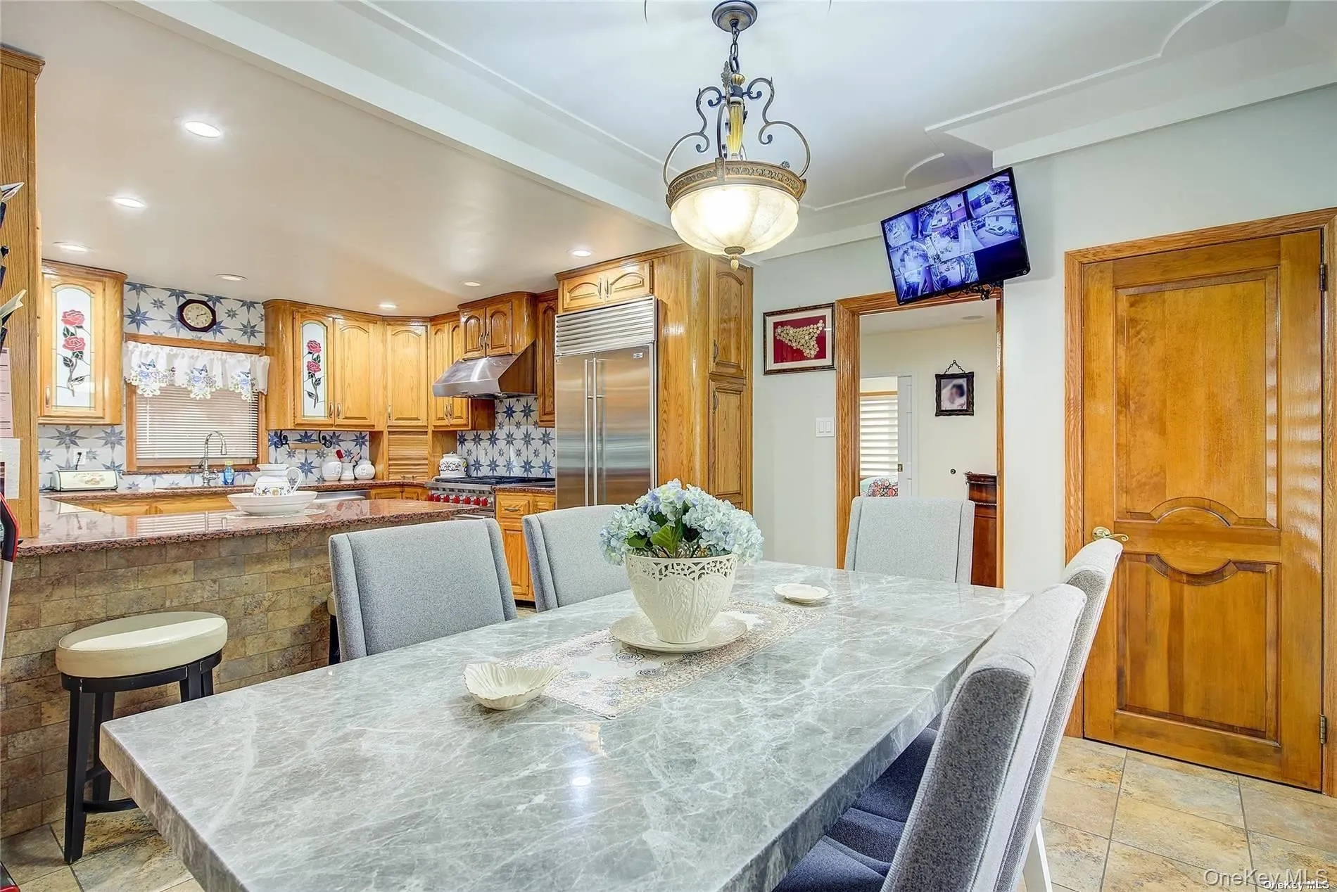 Dining space with recessed lighting and light stone finish floors Dining space with recessed lighting and light stone finish floors