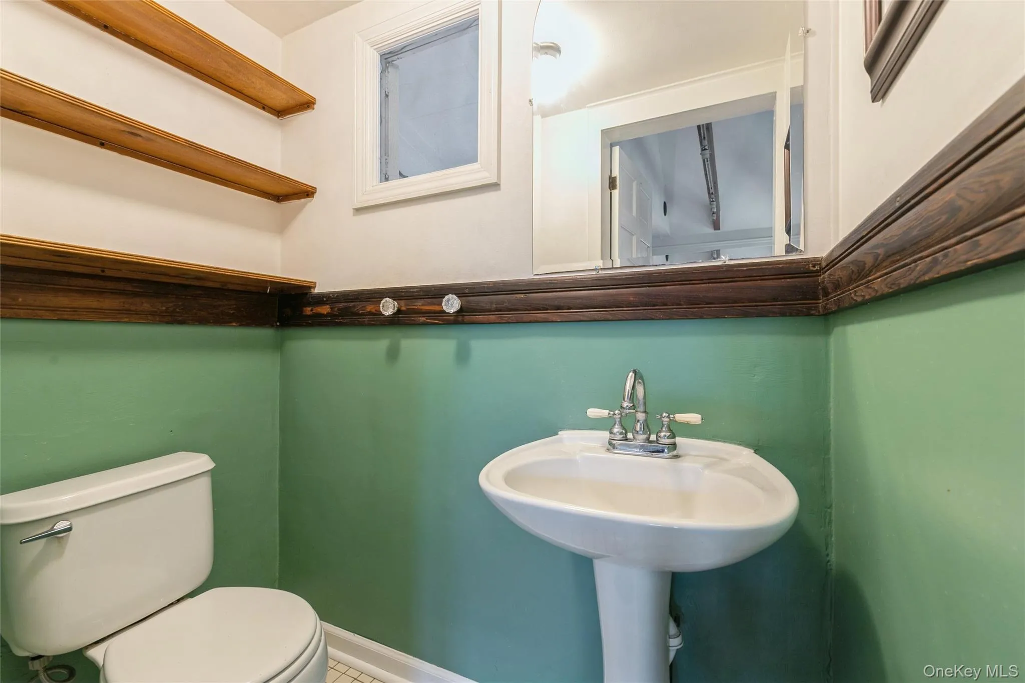 Half bathroom featuring toilet and tile patterned floors Half bathroom featuring toilet and tile patterned floors