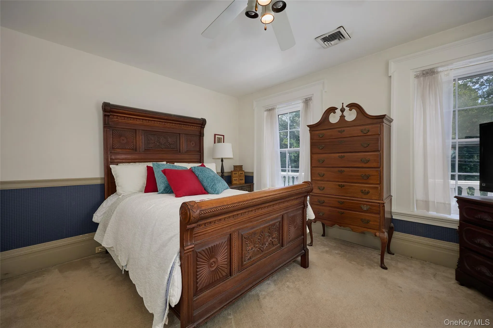 Bedroom with carpet floors and a ceiling fan Bedroom with carpet floors and a ceiling fan