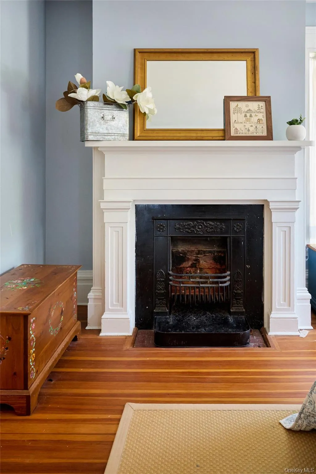 Detailed view of wood finished floors and a fireplace with flush hearth Detailed view of wood finished floors and a fireplace with flush hearth