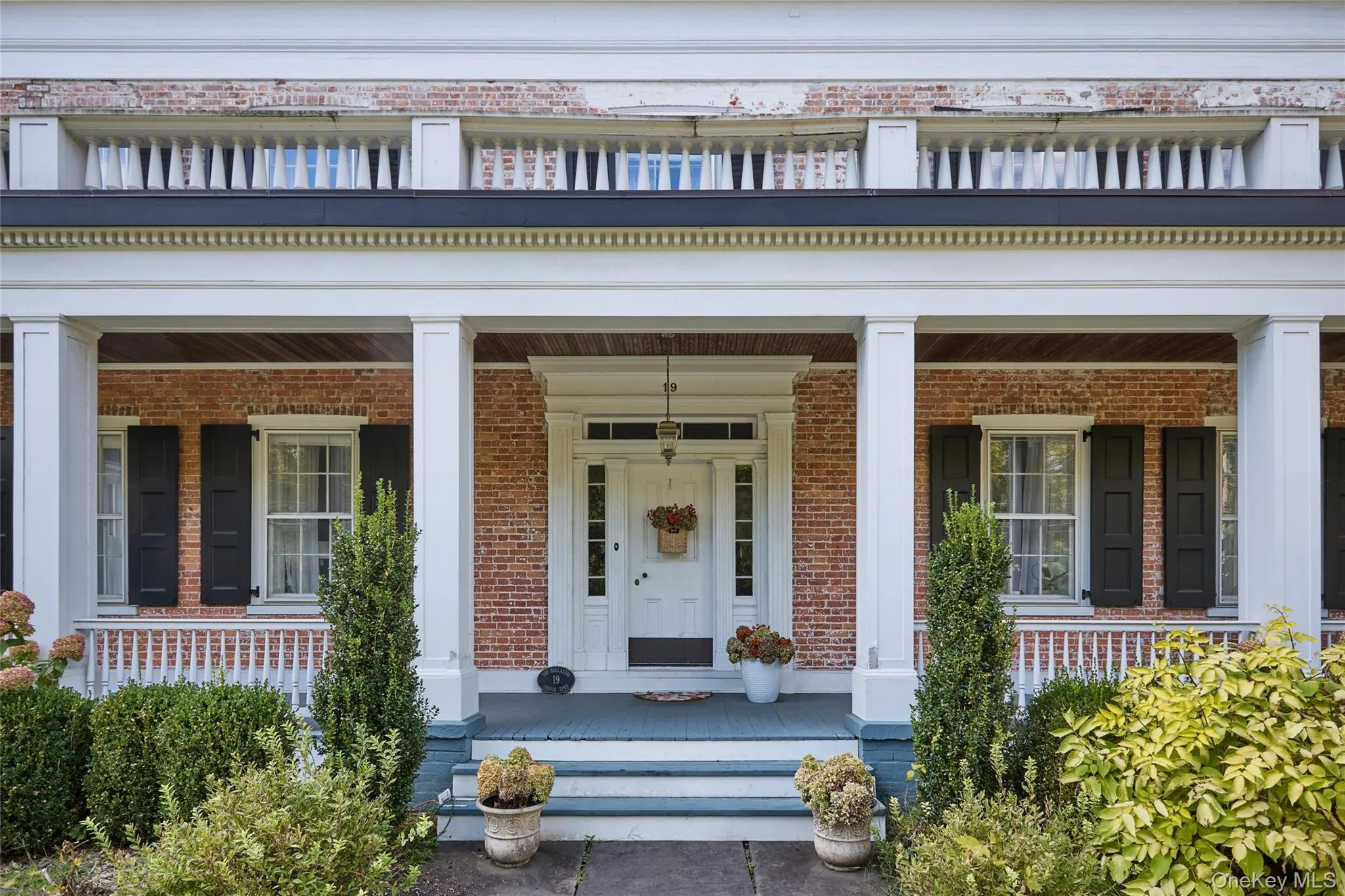 View of exterior entry featuring a porch and brick siding View of exterior entry featuring a porch and brick siding