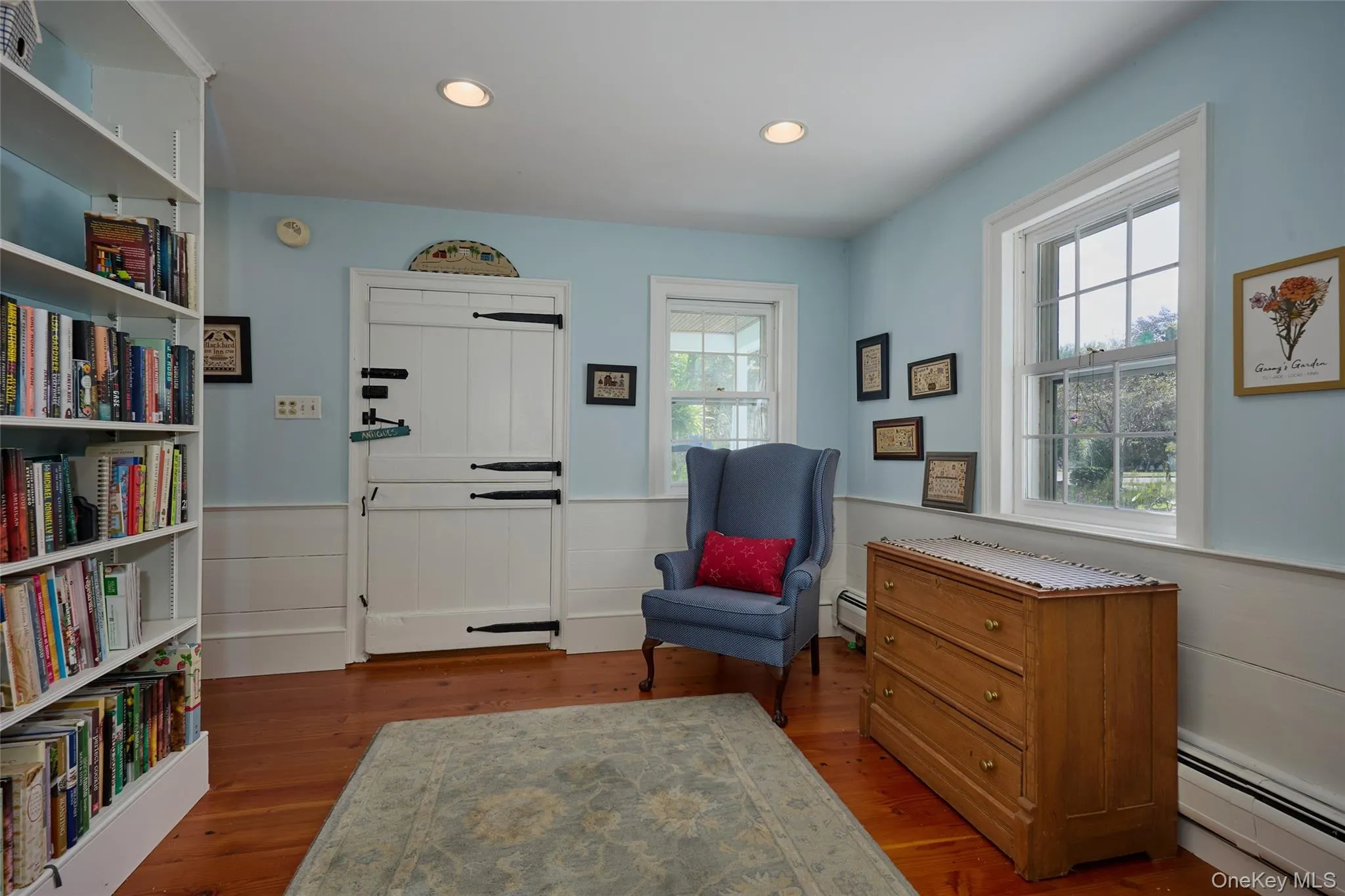Sitting room with wainscoting, a baseboard heating unit, dark wood finished floors, and recessed lighting Sitting room with wainscoting, a baseboard heating unit, dark wood finished floors, and recessed lighting