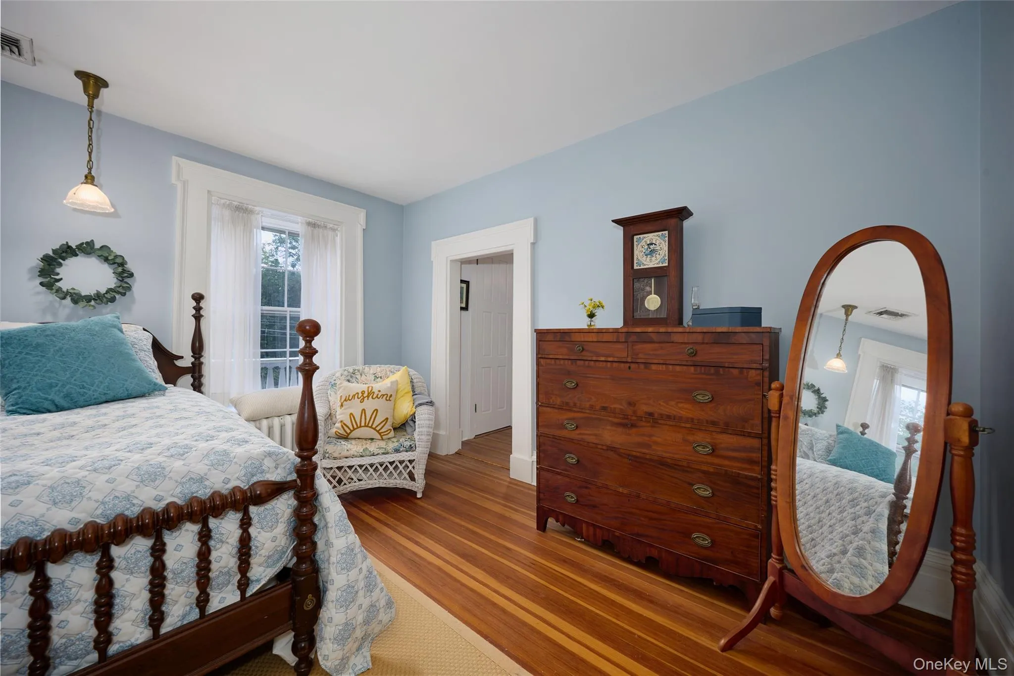 Bedroom featuring wood finished floors and baseboards Bedroom featuring wood finished floors and baseboards