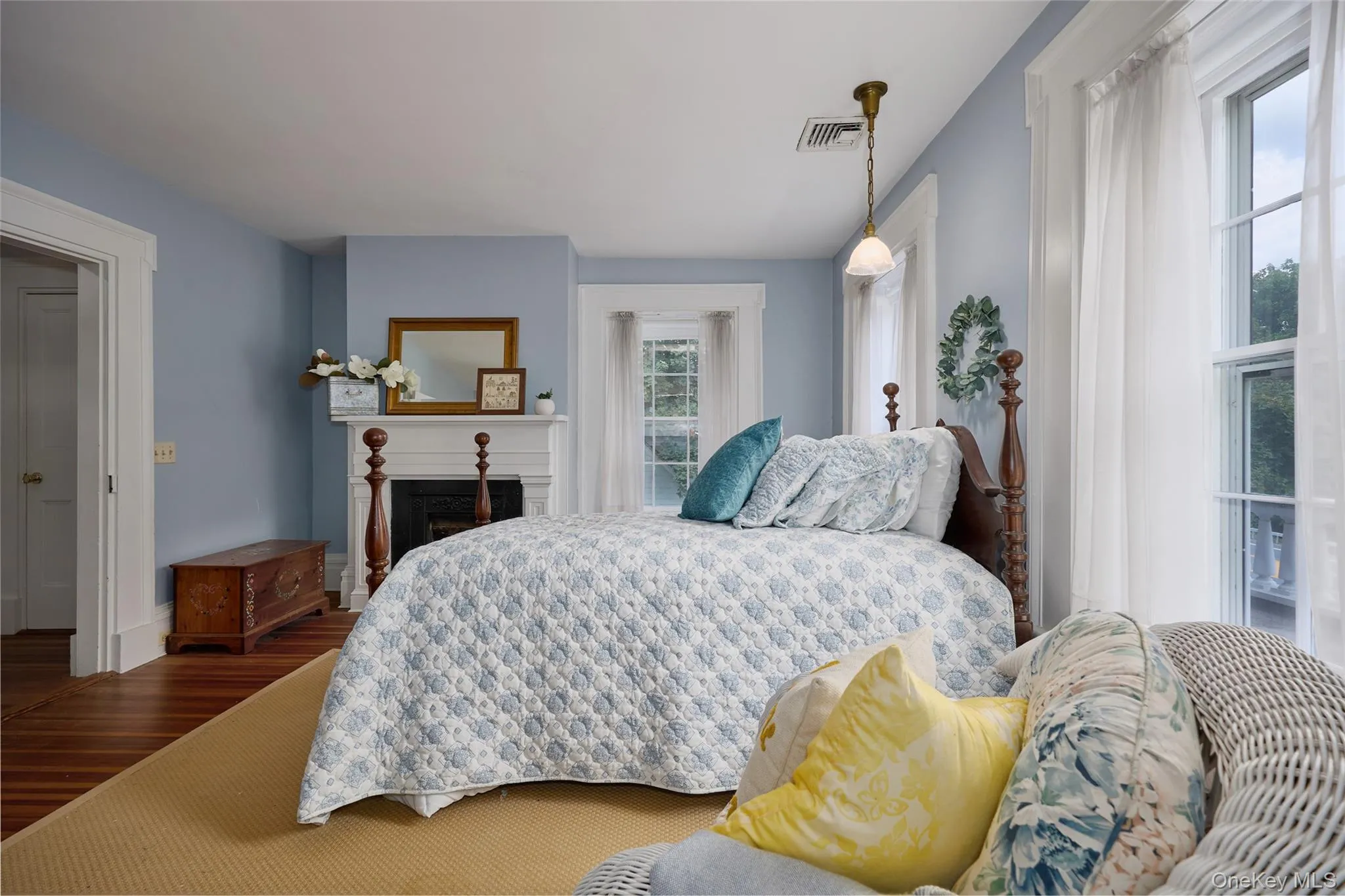 Bedroom with a fireplace and wood finished floors Bedroom with a fireplace and wood finished floors
