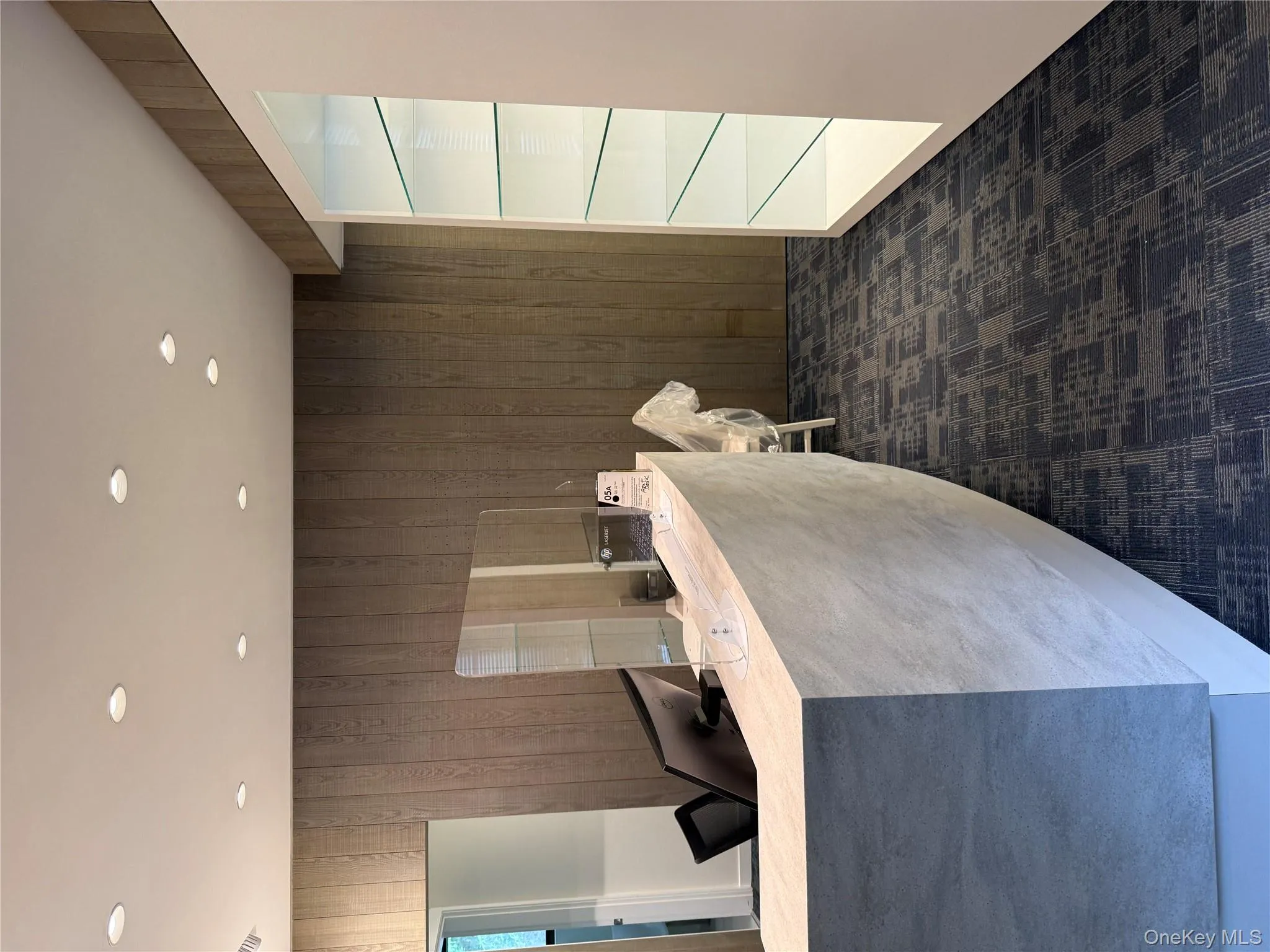 Welcome area with wood walls and recessed lighting Welcome area with wood walls and recessed lighting