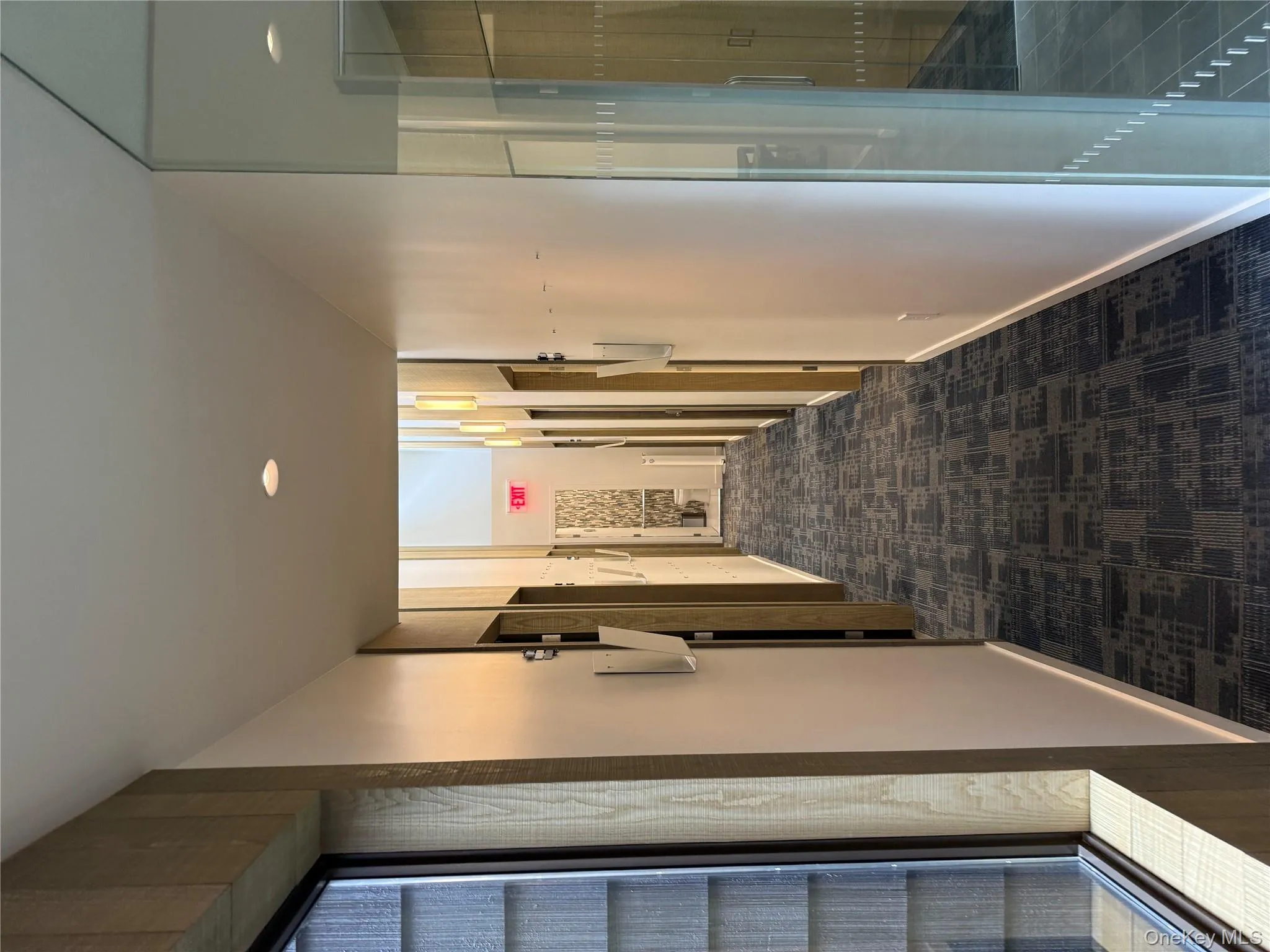 Hallway with dark carpet and recessed lighting Hallway with dark carpet and recessed lighting