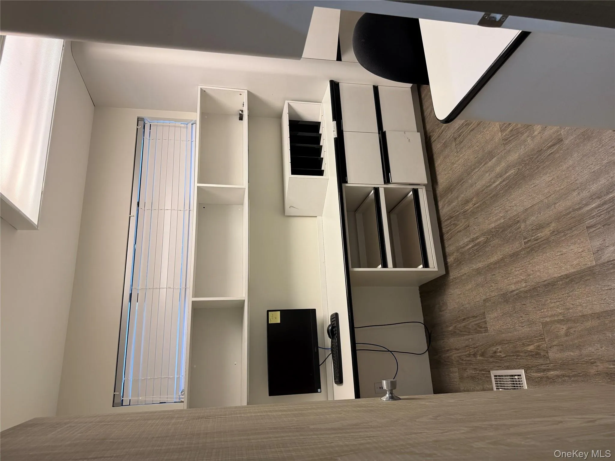 Unfurnished office with dark wood-type flooring and built in study area Unfurnished office with dark wood-type flooring and built in study area