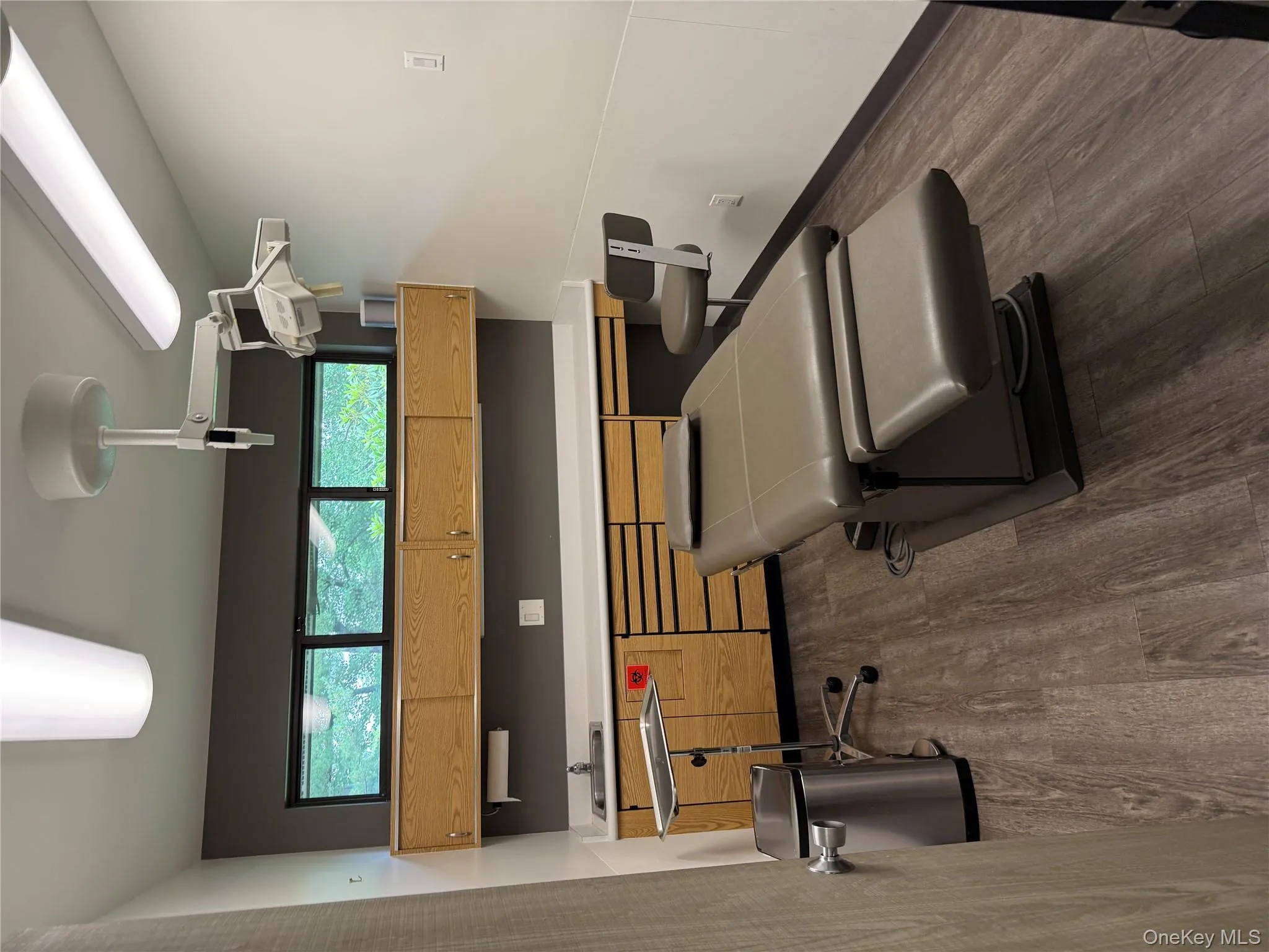 Workout area featuring dark wood-style flooring and healthy amount of natural light Workout area featuring dark wood-style flooring and healthy amount of natural light