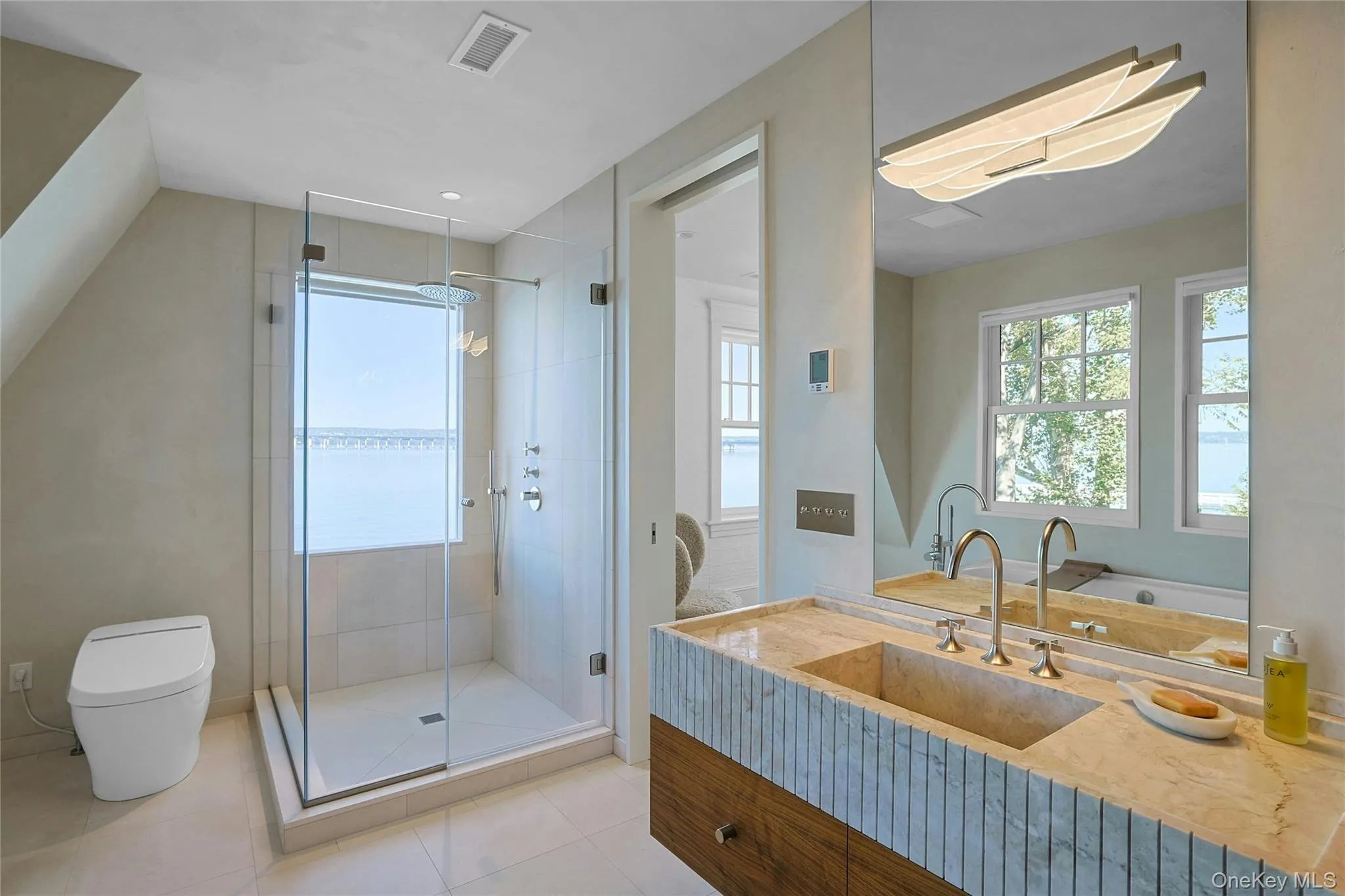 Full bathroom featuring vanity, a shower stall, and light tile patterned floors Full bathroom featuring vanity, a shower stall, and light tile patterned floors