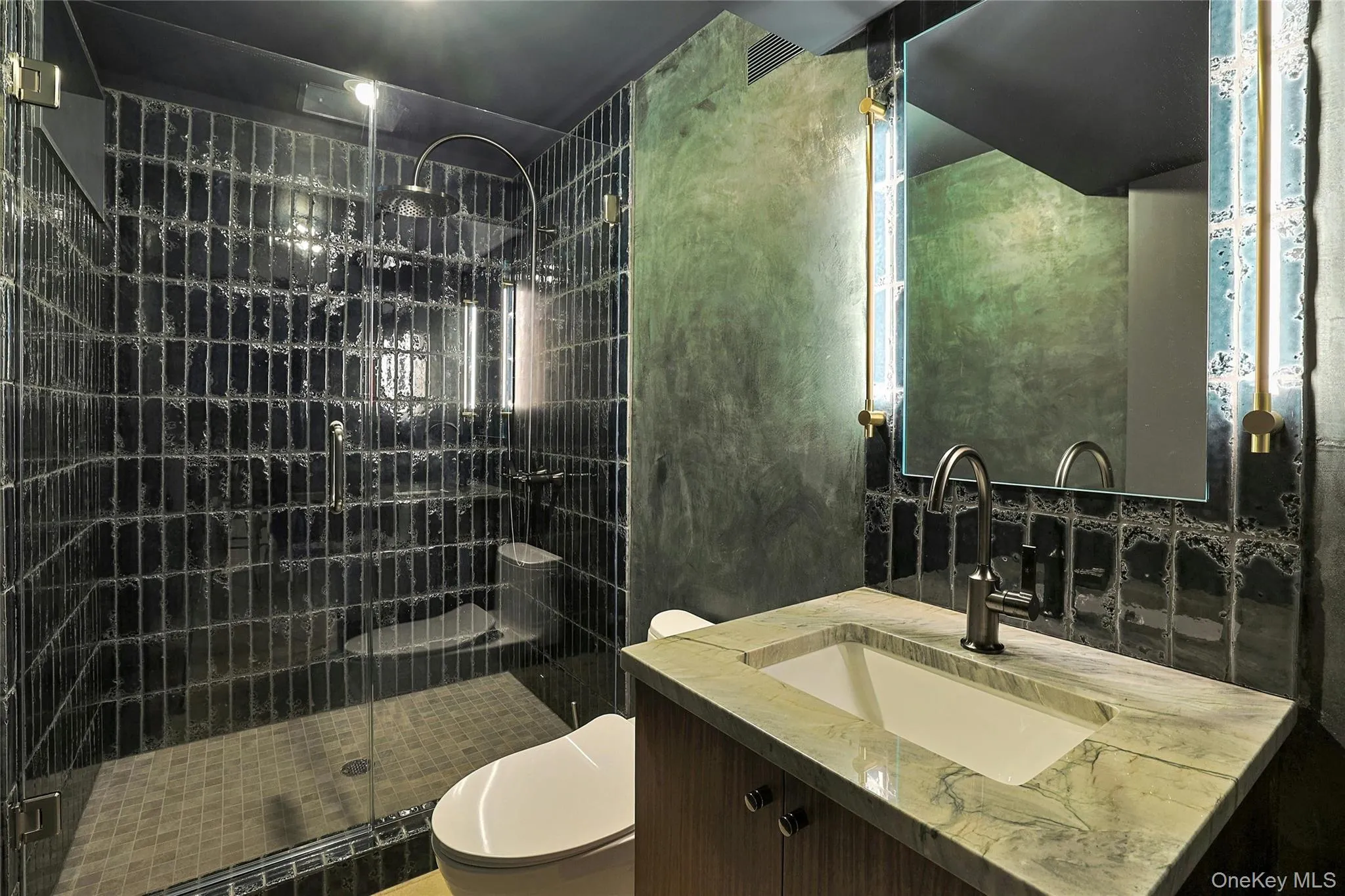 Bathroom featuring vanity and a shower stall Bathroom featuring vanity and a shower stall