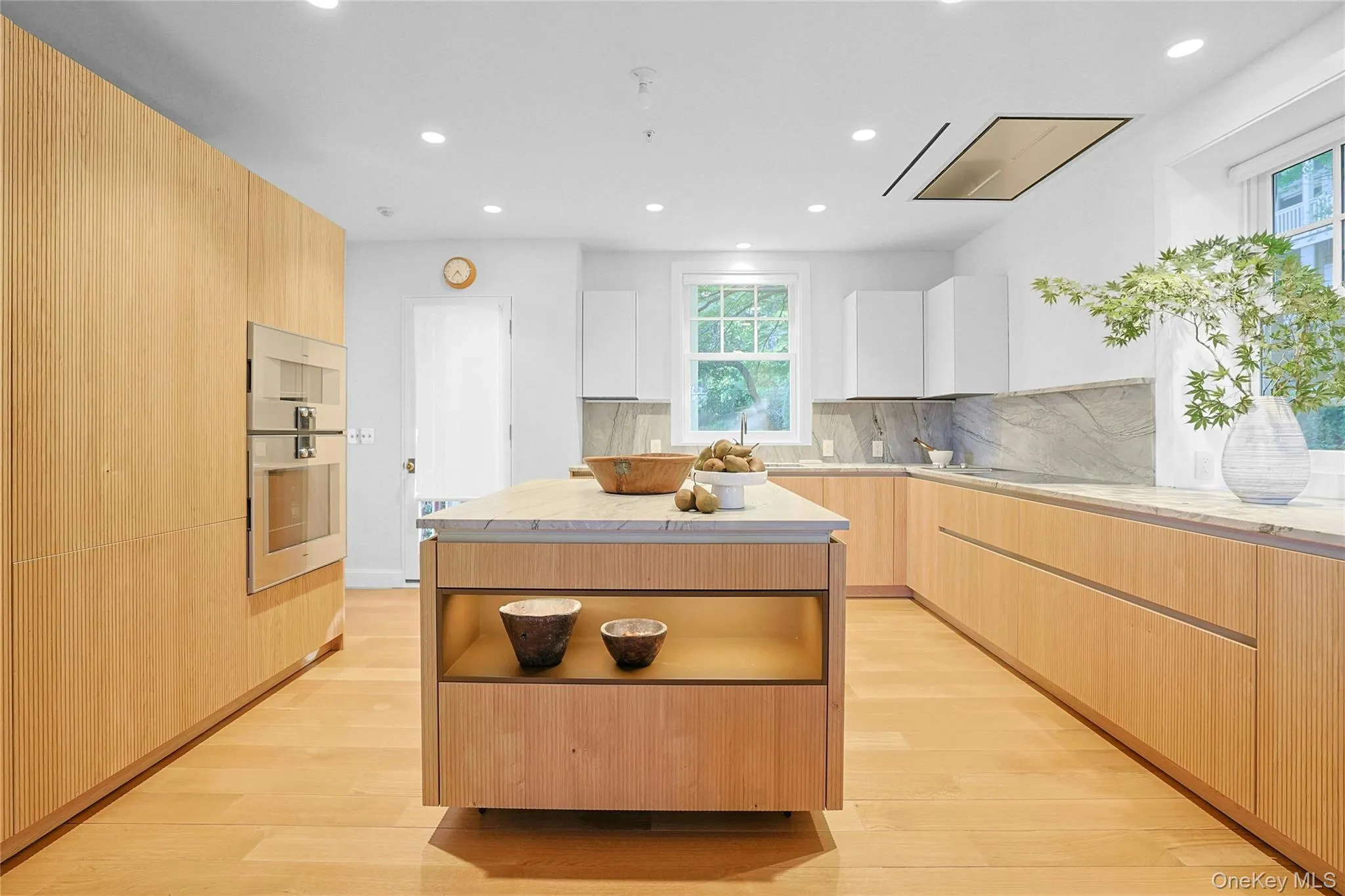 Kitchen with light brown cabinetry, modern cabinets, a kitchen island, recessed lighting, and light wood-type flooring Kitchen with light brown cabinetry, modern cabinets, a kitchen island, recessed lighting, and light wood-type flooring