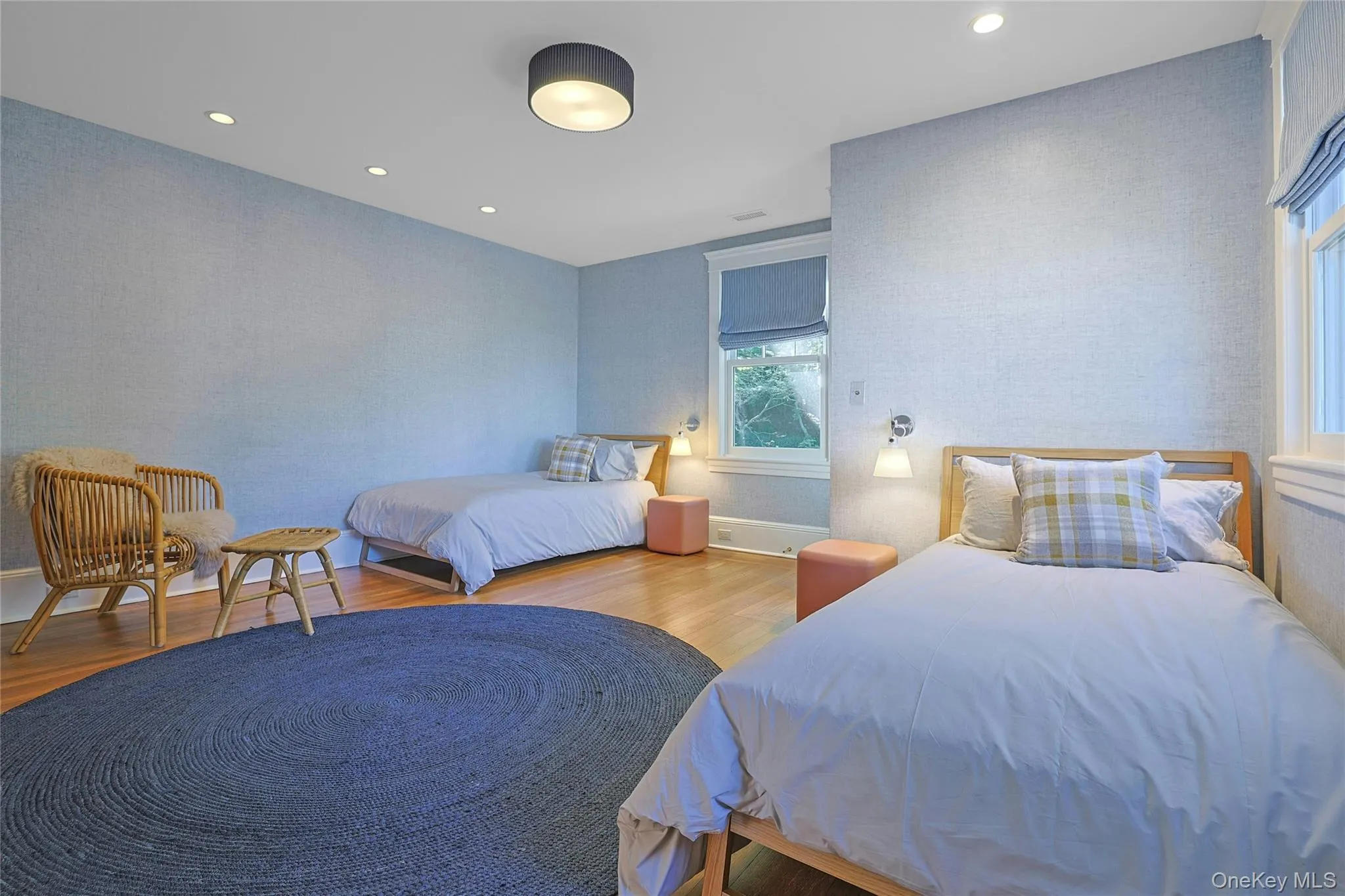 Bedroom with wallpapered walls, wood finished floors, and recessed lighting Bedroom with wallpapered walls, wood finished floors, and recessed lighting