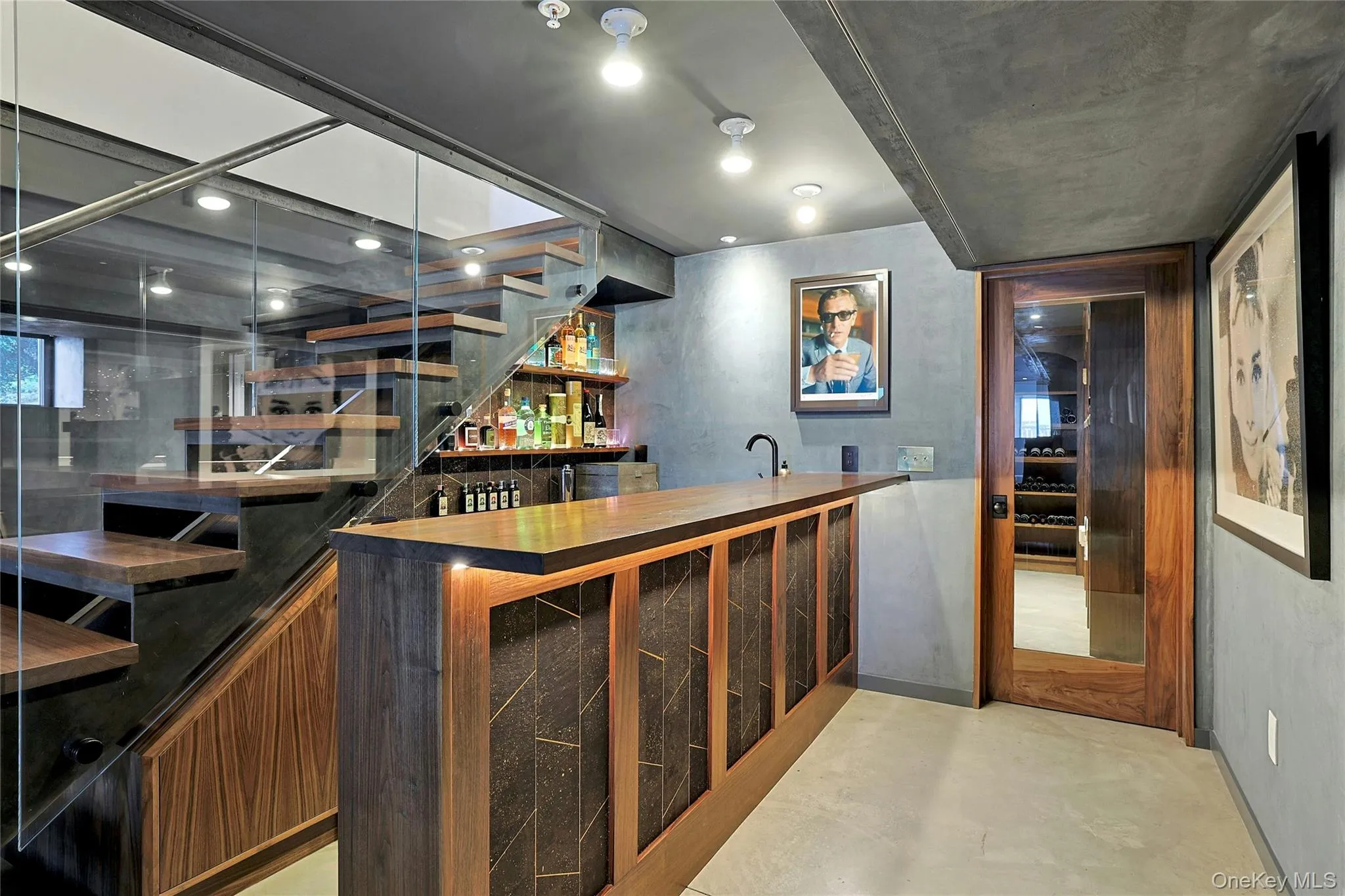 Indoor wet bar with wooden counters, stairs, finished concrete floors, and open shelves Indoor wet bar with wooden counters, stairs, finished concrete floors, and open shelves