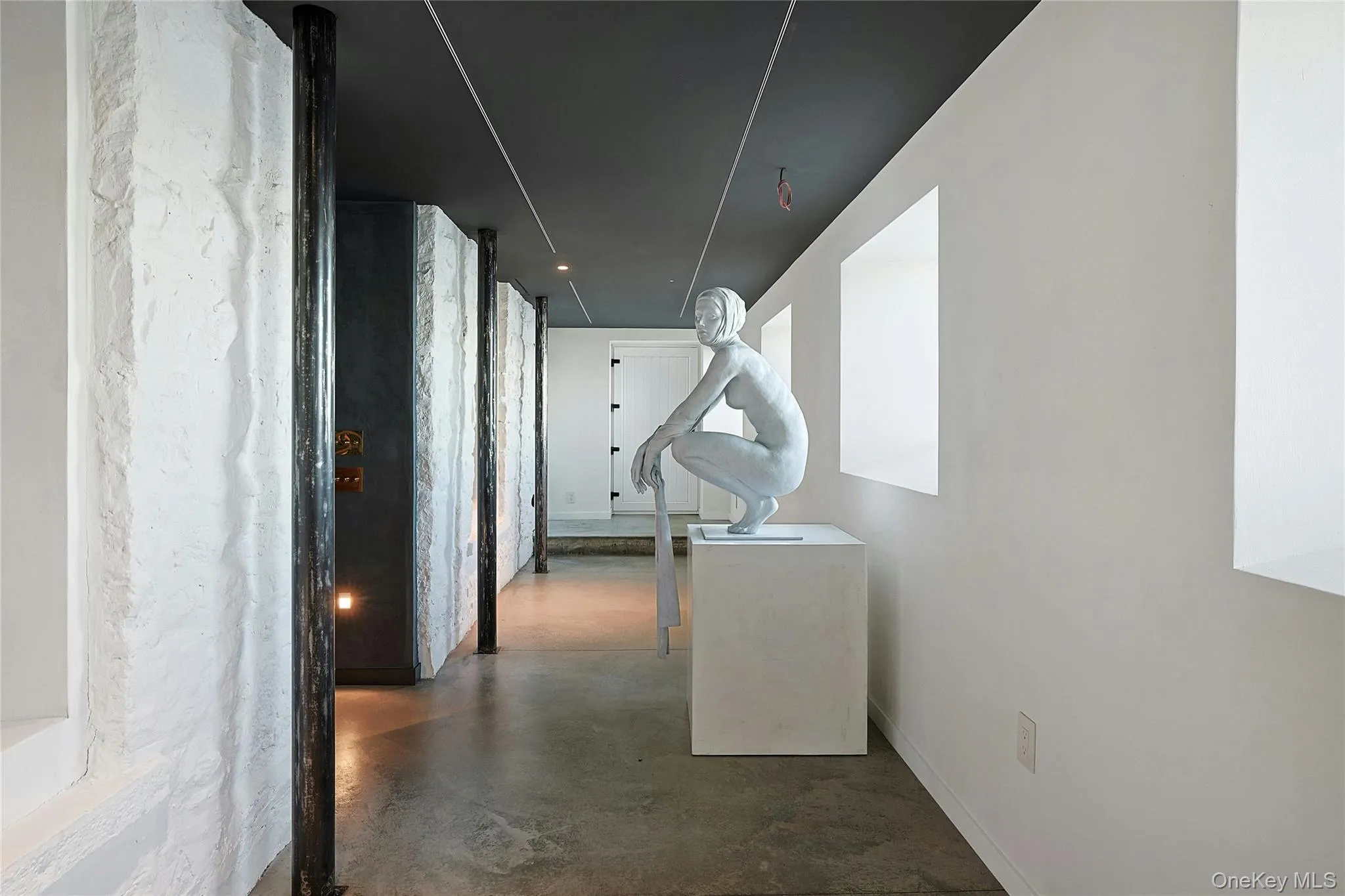 Hall featuring concrete floors Hall featuring concrete floors