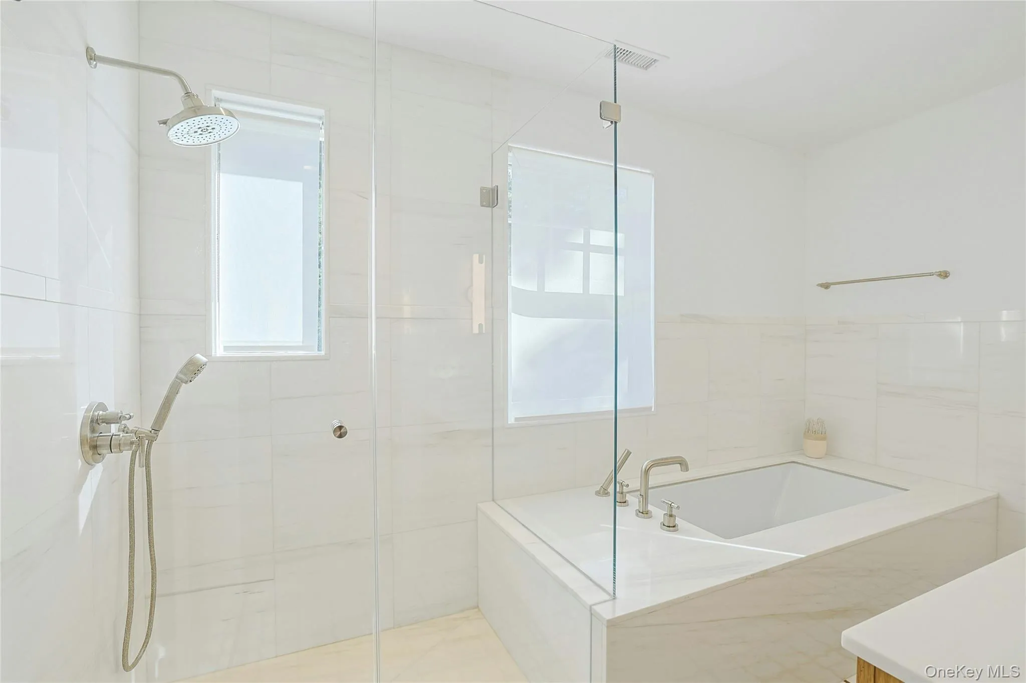 Full bath with a stall shower and a garden tub Full bath with a stall shower and a garden tub