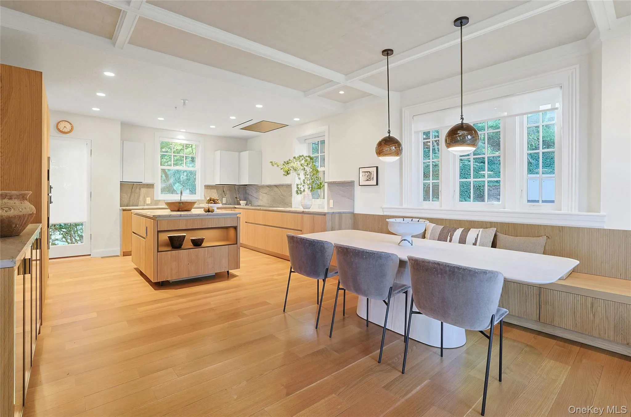 Kitchen with light brown cabinetry, modern cabinets, white cabinets, breakfast area, and light wood-style floors Kitchen with light brown cabinetry, modern cabinets, white cabinets, breakfast area, and light wood-style floors