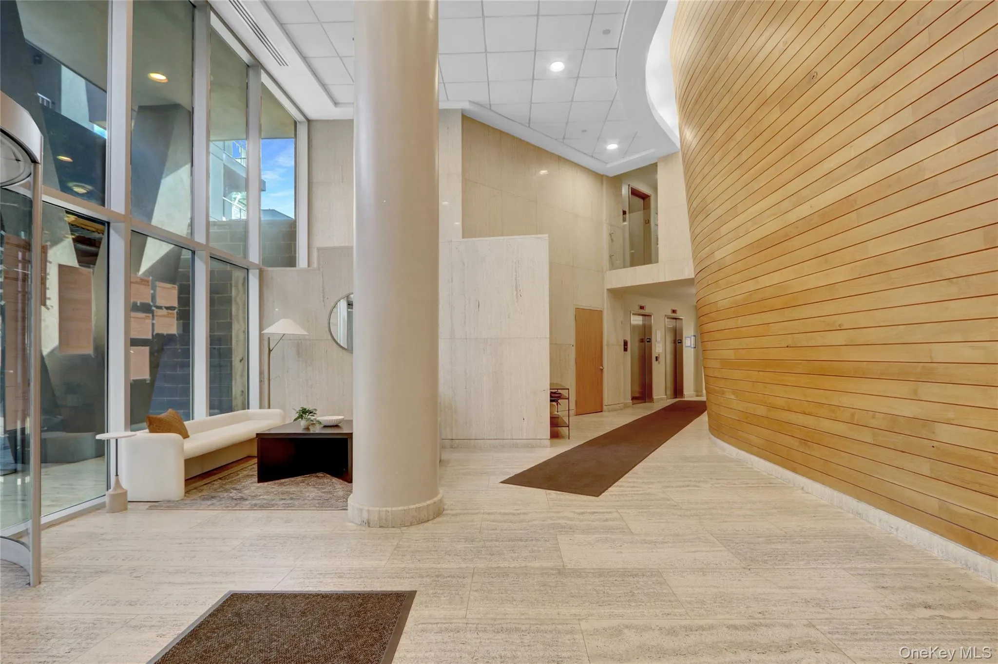 Common area with a high ceiling, wooden walls, recessed lighting, and floor to ceiling windows Common area with a high ceiling, wooden walls, recessed lighting, and floor to ceiling windows